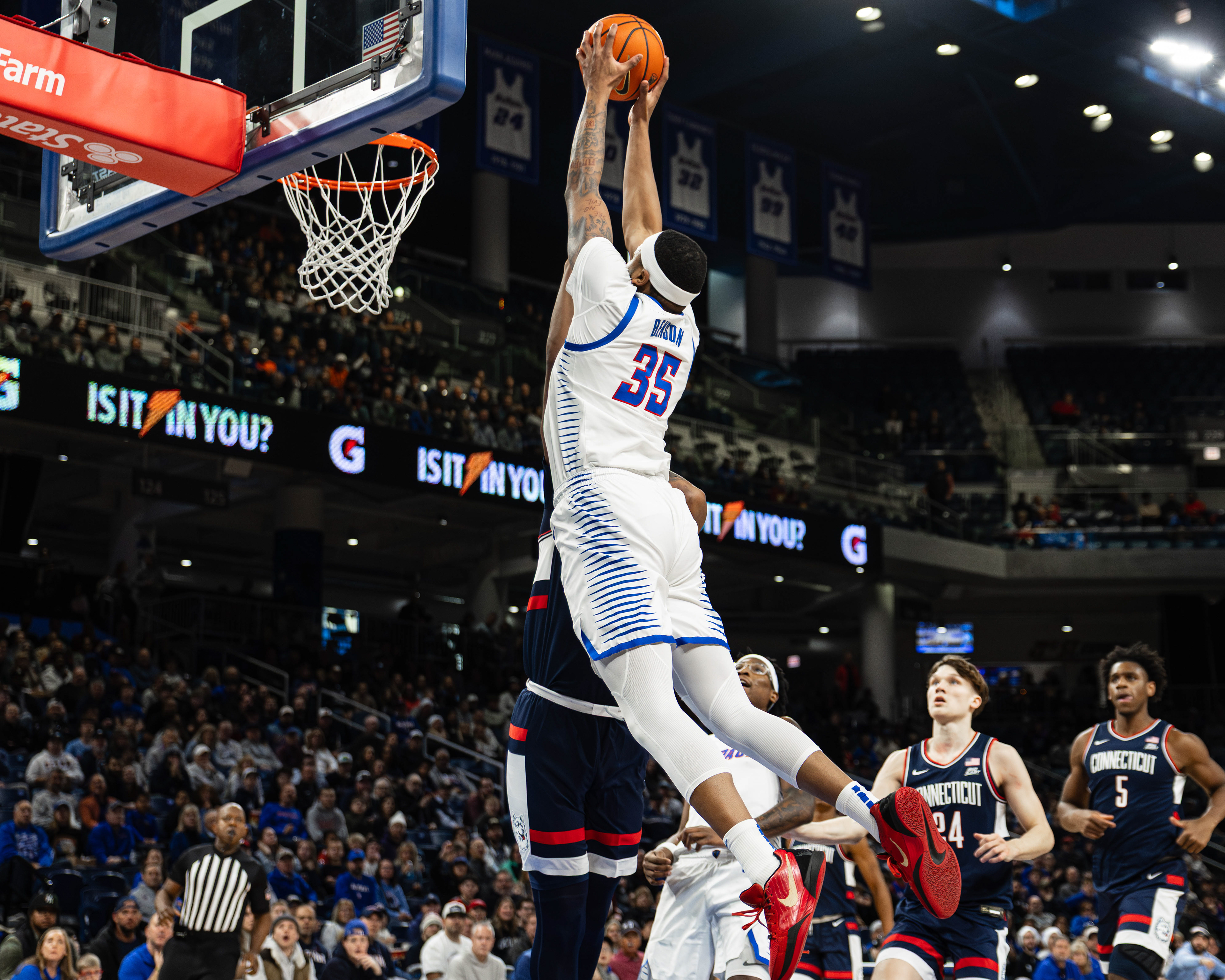 DePaul basketball player N.J. Benson goes in for a dunk in the game against UConn, at Wintrust Arena, located in Chicago, Illinois, on December 21, 2025.