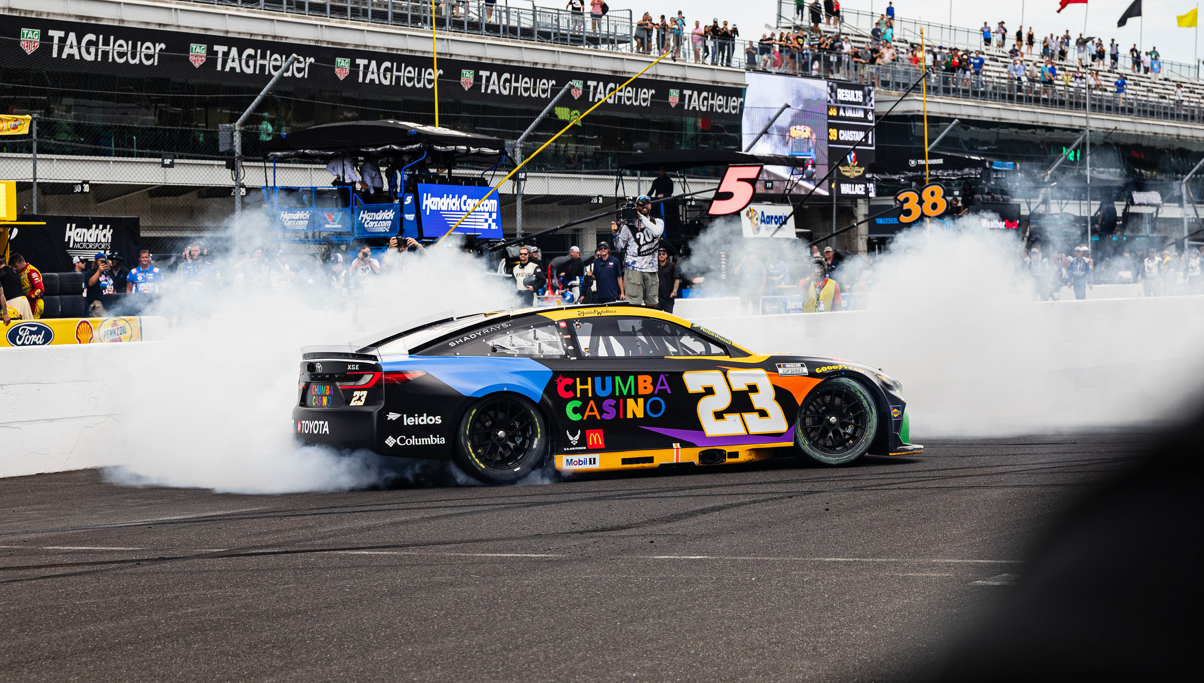 Bubba Wallace, driver of the No. 23 Toyota Camry for 23XI Racing, does a burnout on the frontstretch after winning the Brickyard 400 at the Indianapolis Motor Speedway, located in Speedway, Indiana, on July 27, 2025.