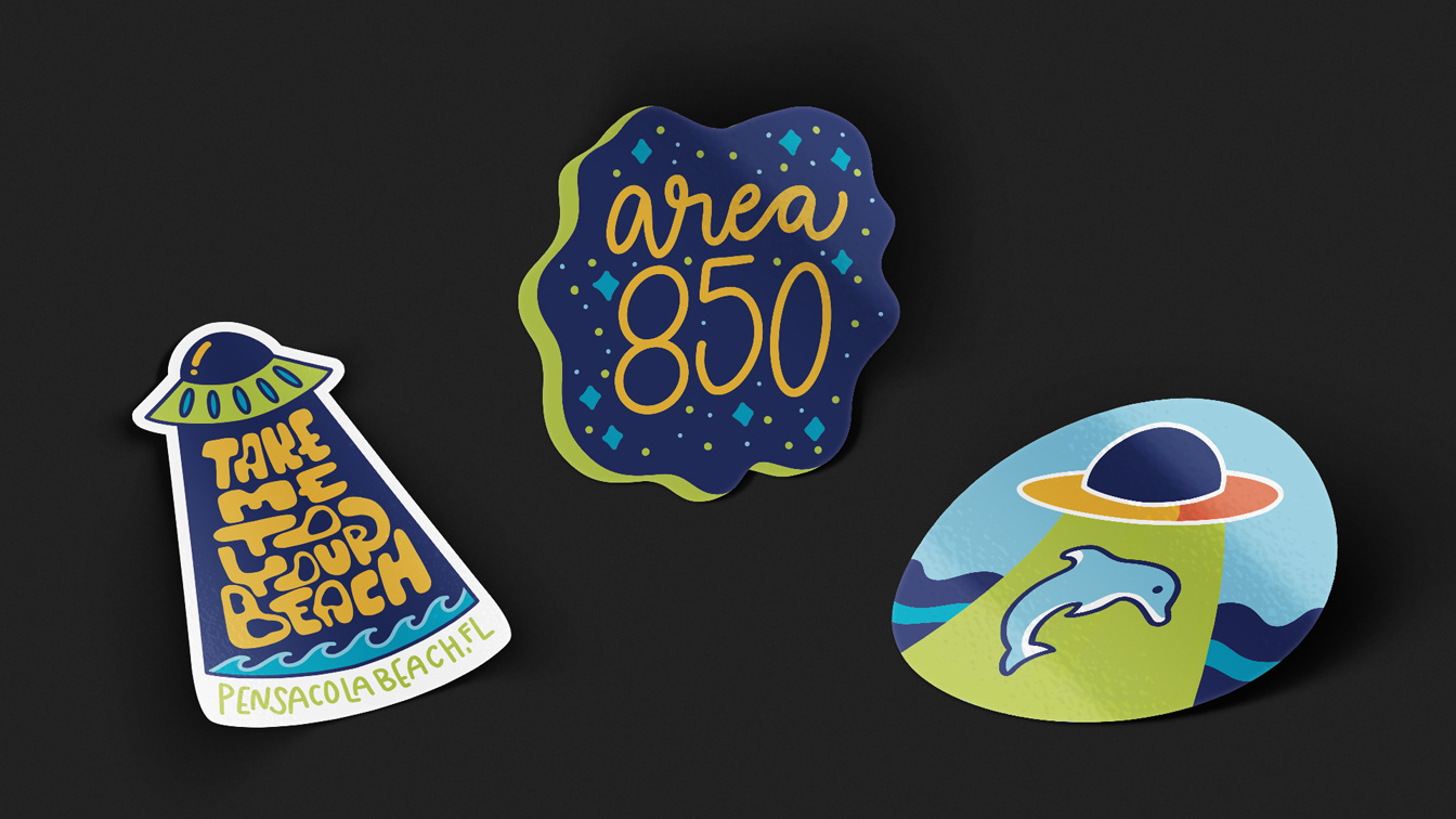 Mockups of three stickers: "Take me to your beach Pensacola Beach, FL," "Area 850," and illustration of a dolphin being abducted by a UFO