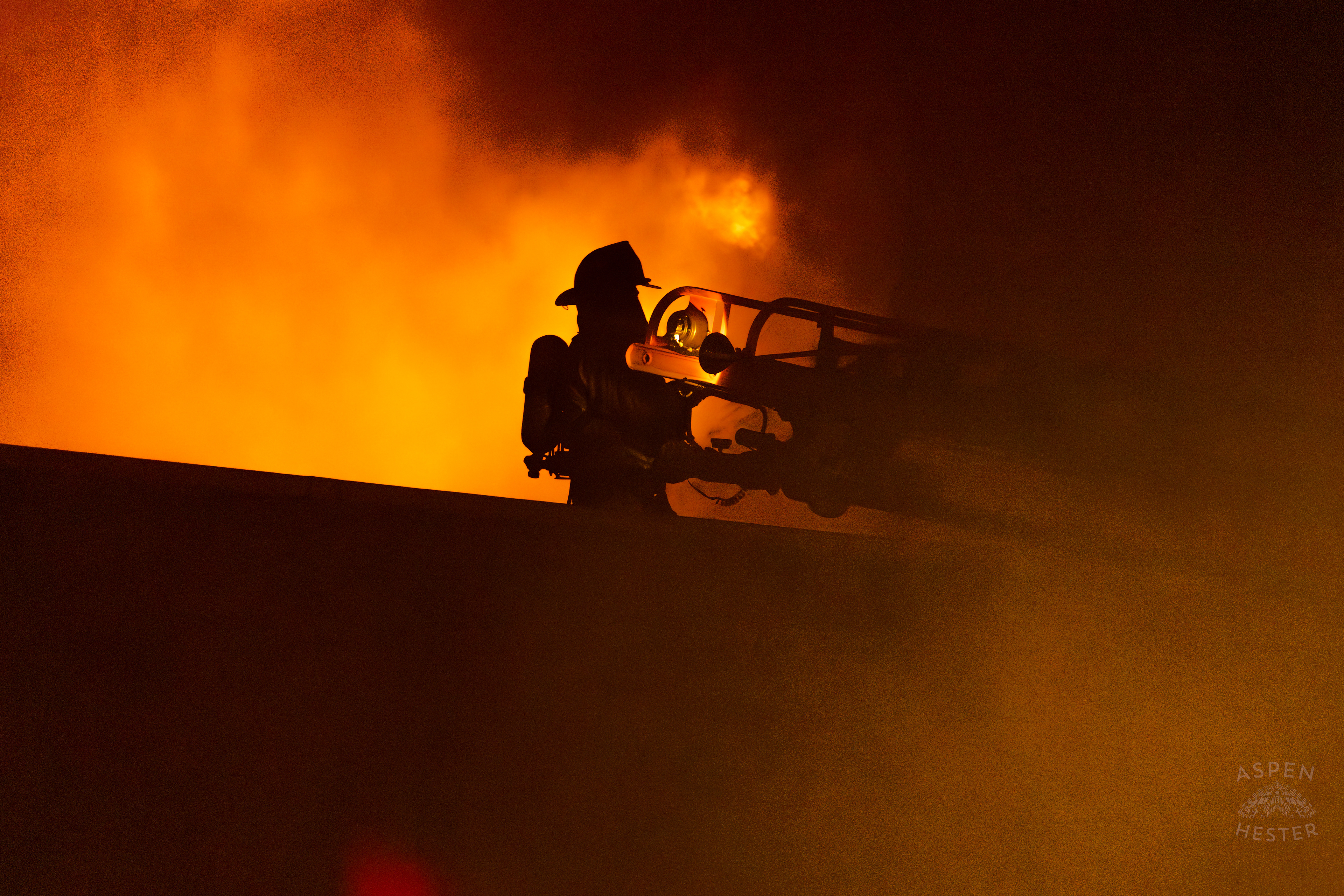 Firefighter Stands on A Nearby Roof In Front of The Massive 3 Alarm Blaze Engulfing The Vacant St. Paul's German Evangelical Church on East Broadway. October 9th, 2024/Aspen Hester
