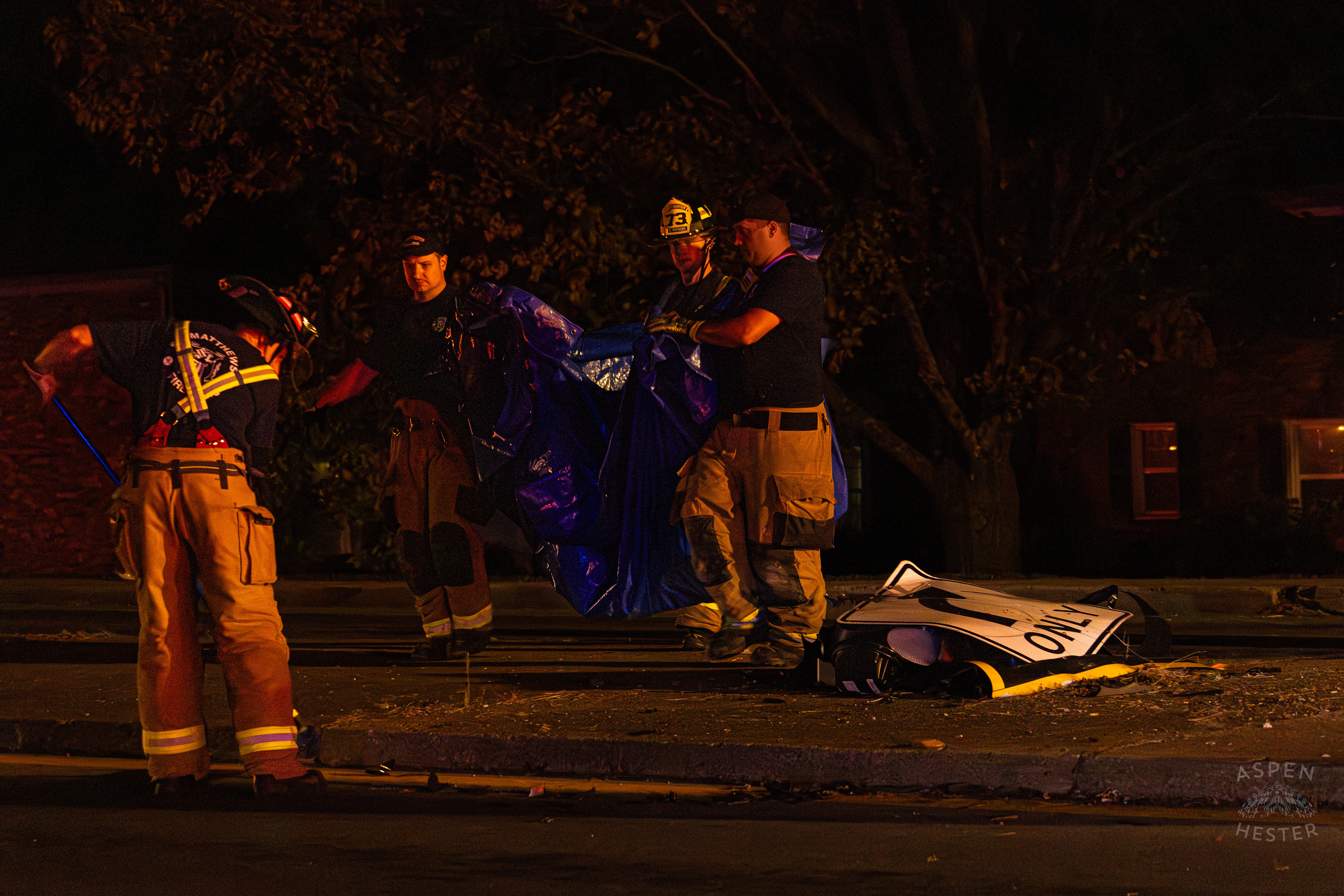 St. Matthews Firefighters Sweeping The Street and Gathering Debris so A Crew from Tony’s Wreckers Can Begin Removing The Piper Cherokee Plane from the Road after it Crash Landed, Taking Out Utility Poles, and Hitting A Car on Breckenridge Lane and Kresge Way. October 11th, 2024/Aspen Hester 