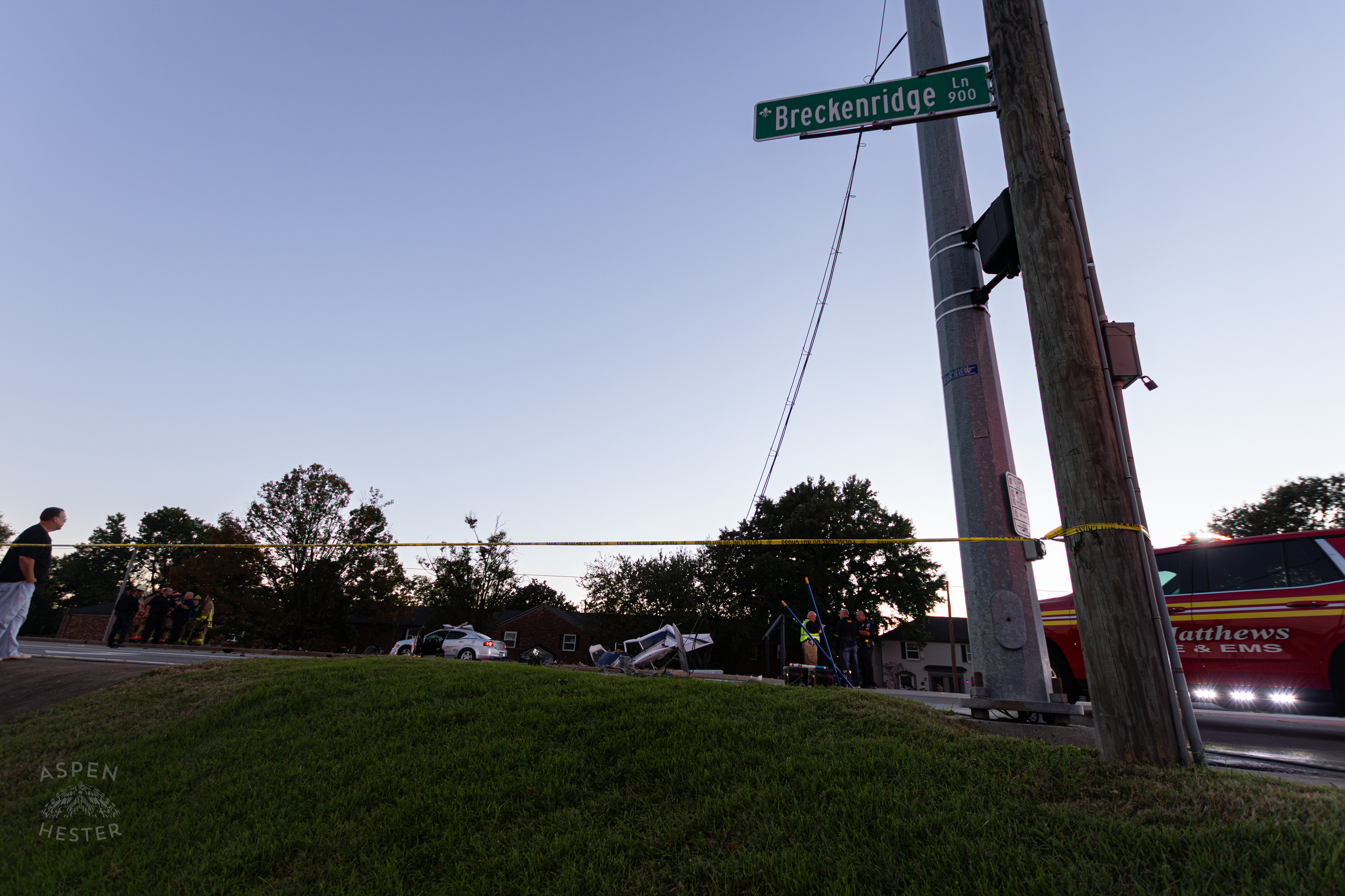 Street Sign for Breckenridge Lane Looms Over The Destruction Left after A Piper Cherokee Plane Crash Landed, Taking Out Utility Poles, and Hitting A Car on Breckenridge Lane and Kresge Way. October 11th, 2024/Aspen Hester 