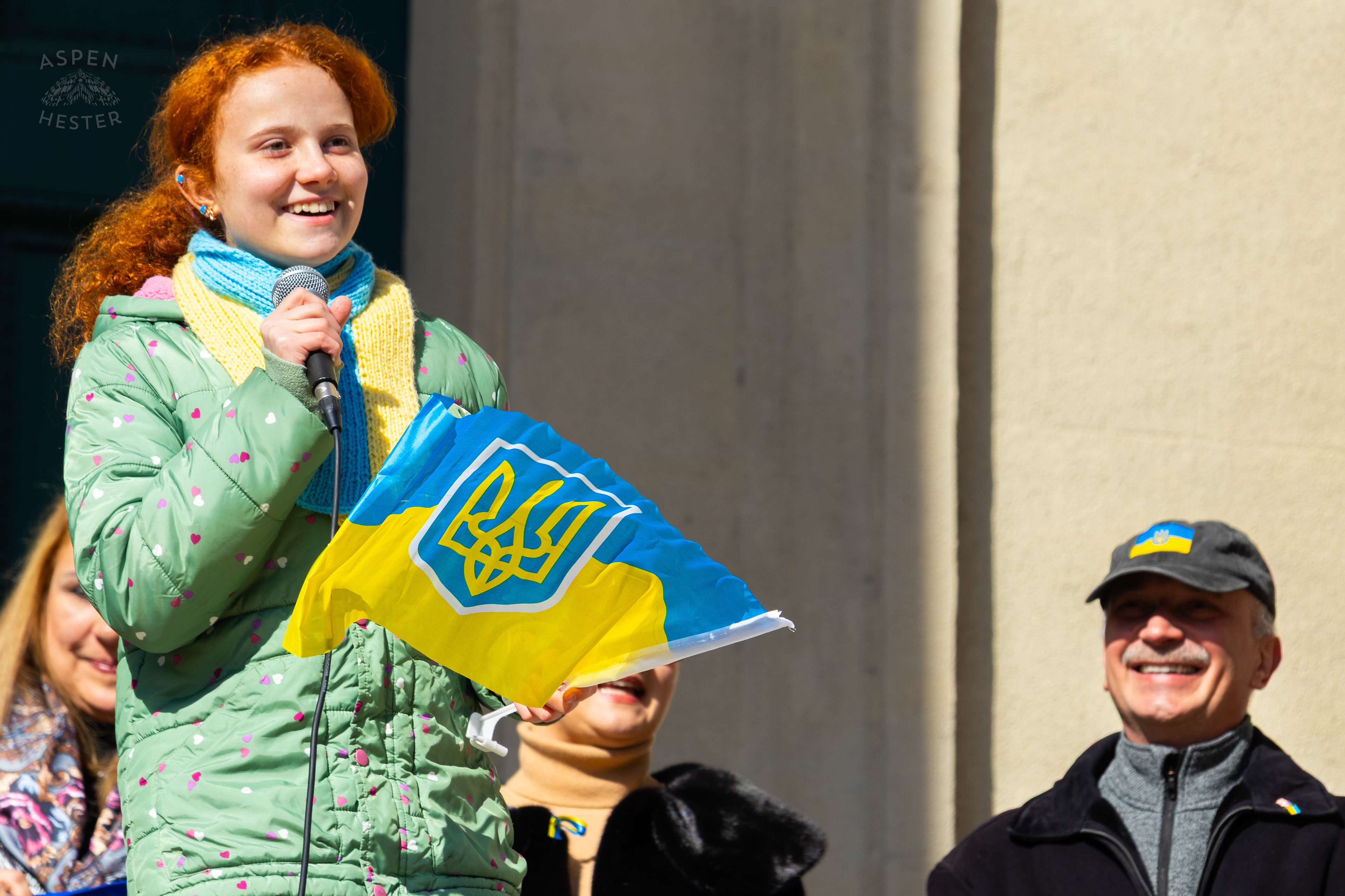 A Young Ukrainian Louisvillians Sings The Ukraine National Anthem While Holding Their Flag as The Community Rallies in Support of Ukraine. March 2nd, 2025/Aspen Hester