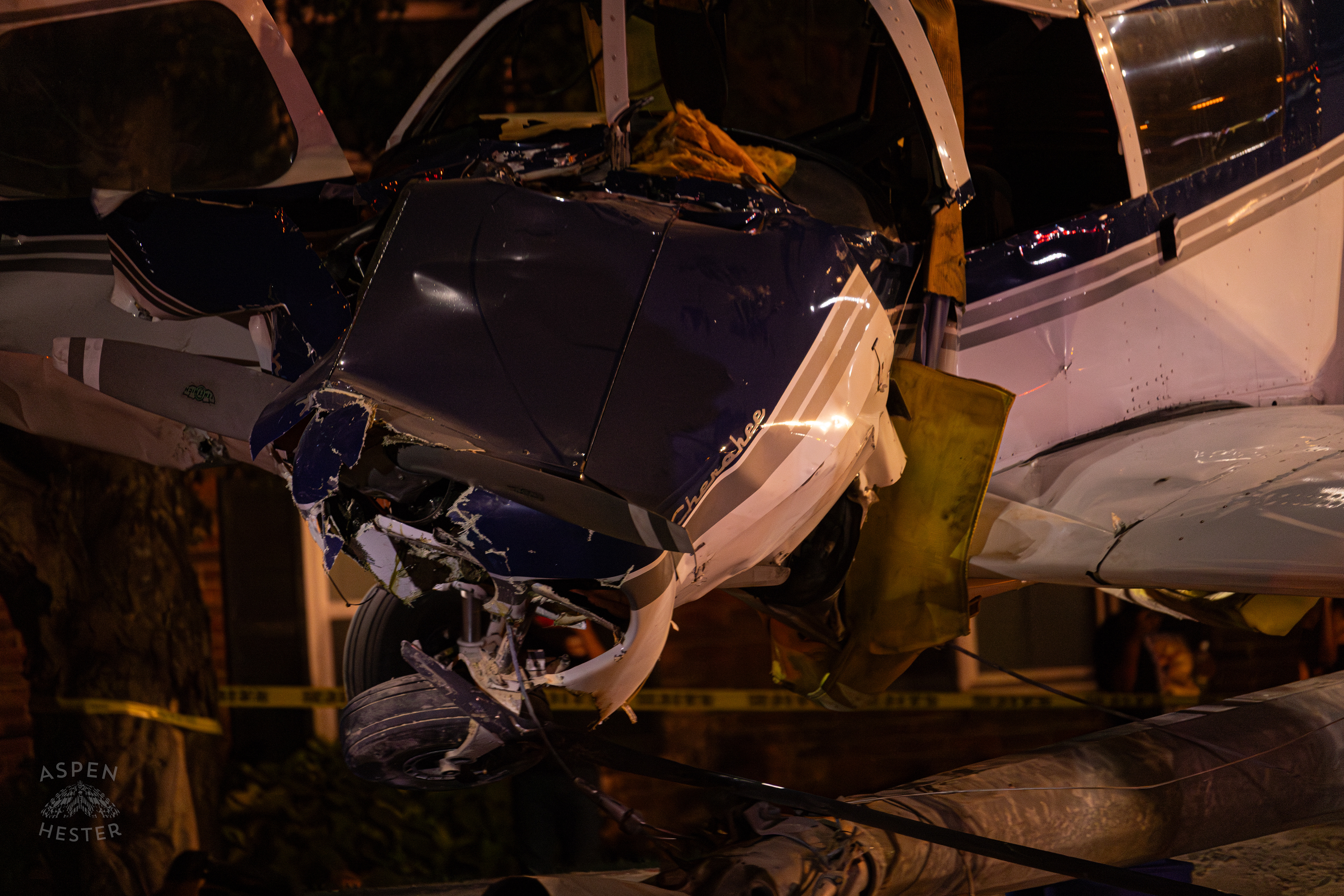 The Piper Cherokee Plane Being Lifted from the Road after it Crash Landed, Taking Out Utility Poles, and Hitting A Car on Breckenridge Lane and Kresge Way. October 11th, 2024/Aspen Hester 