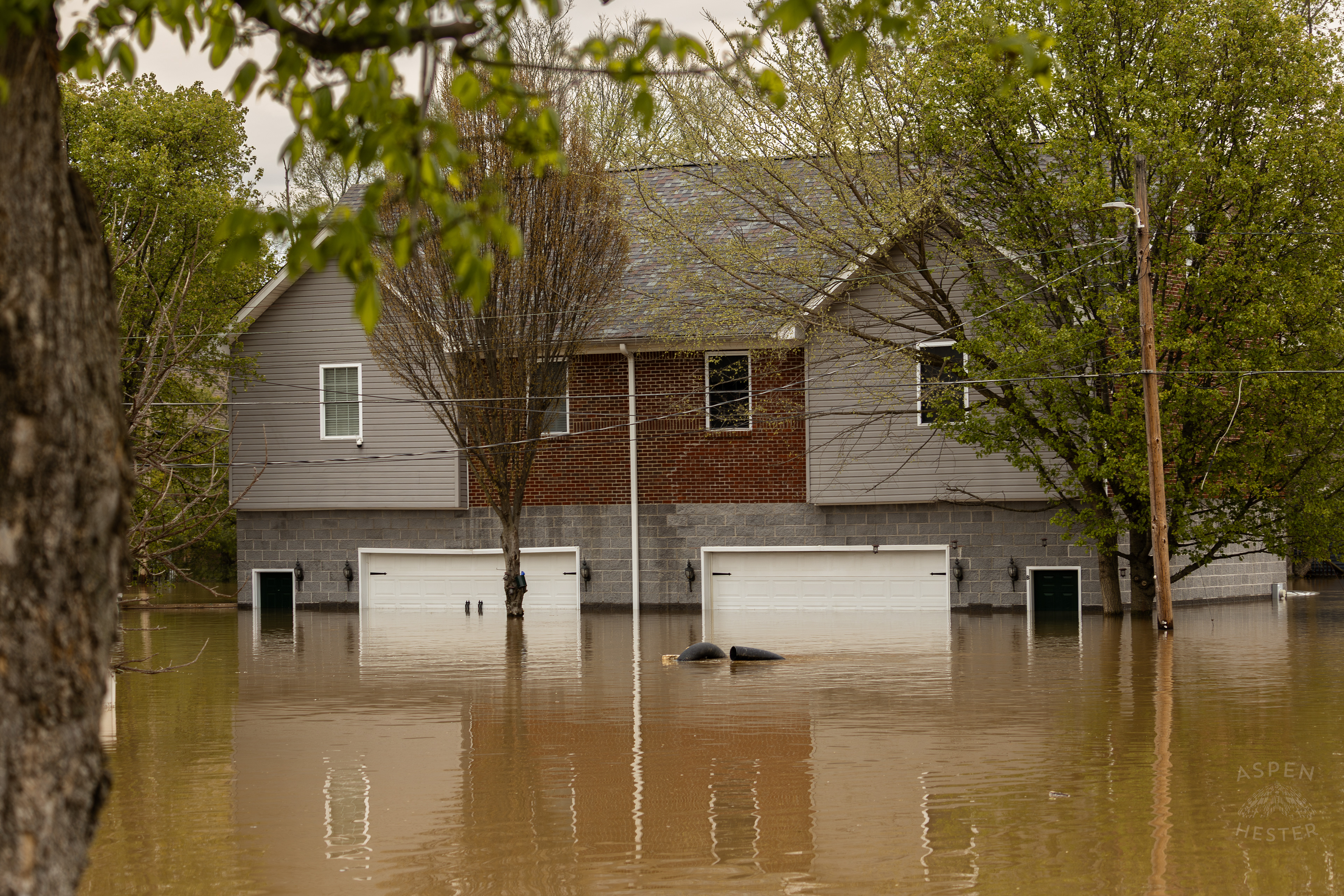 Water Creeping Halfway Up Garage Doors As The Ohio River Reaches Its Crest Amid The Historic Flooding in Utica Indiana. April 9th, 2025/Aspen Hester