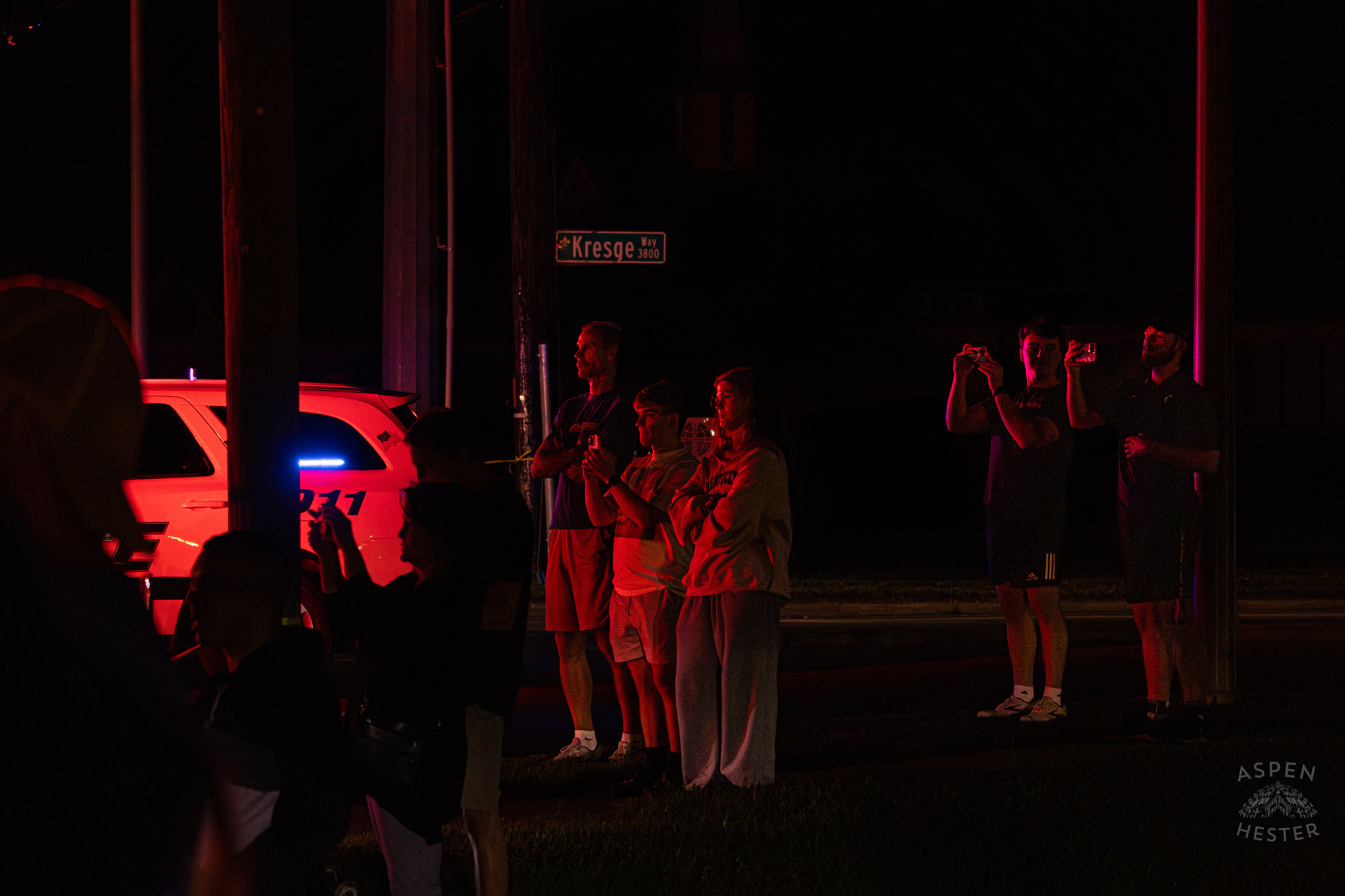 Onlookers Watching as Tony's Wreckers Crew Works to Remove The Piper Cherokee Plane from the Road after it Crash Landed, Taking Out Utility Poles, and Hitting A Car on Breckenridge Lane and Kresge Way. October 11th, 2024/Aspen Hester