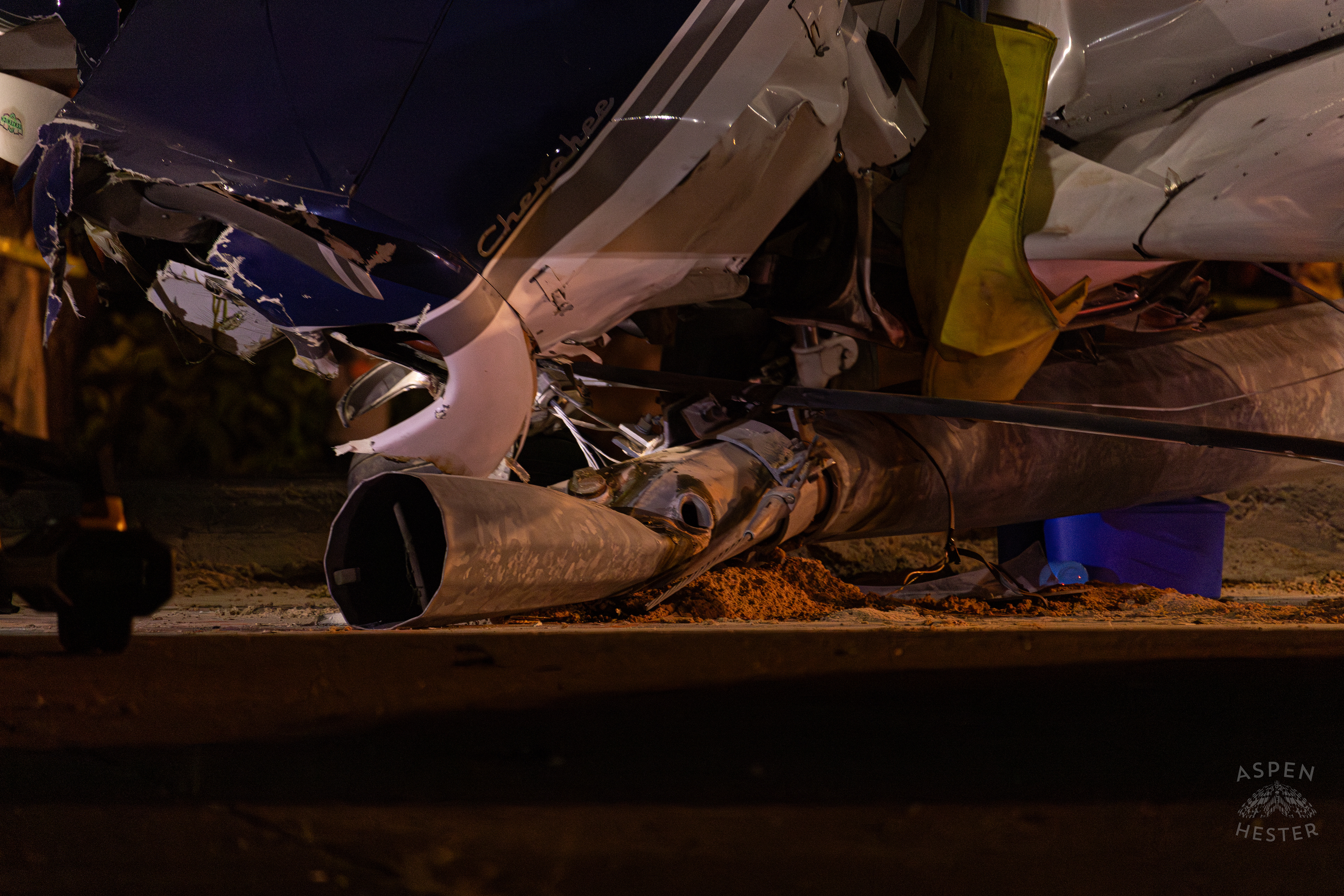 What’s Left of A Utility Pole Revealed From Under The Plane as A Tony’s Wreckers Crew Works to Remove The Piper Cherokee Plane from the Road after it Crash Landed, Taking Out Utility Poles, and Hitting A Car on Breckenridge Lane and Kresge Way. October 11th, 2024/Aspen Hester