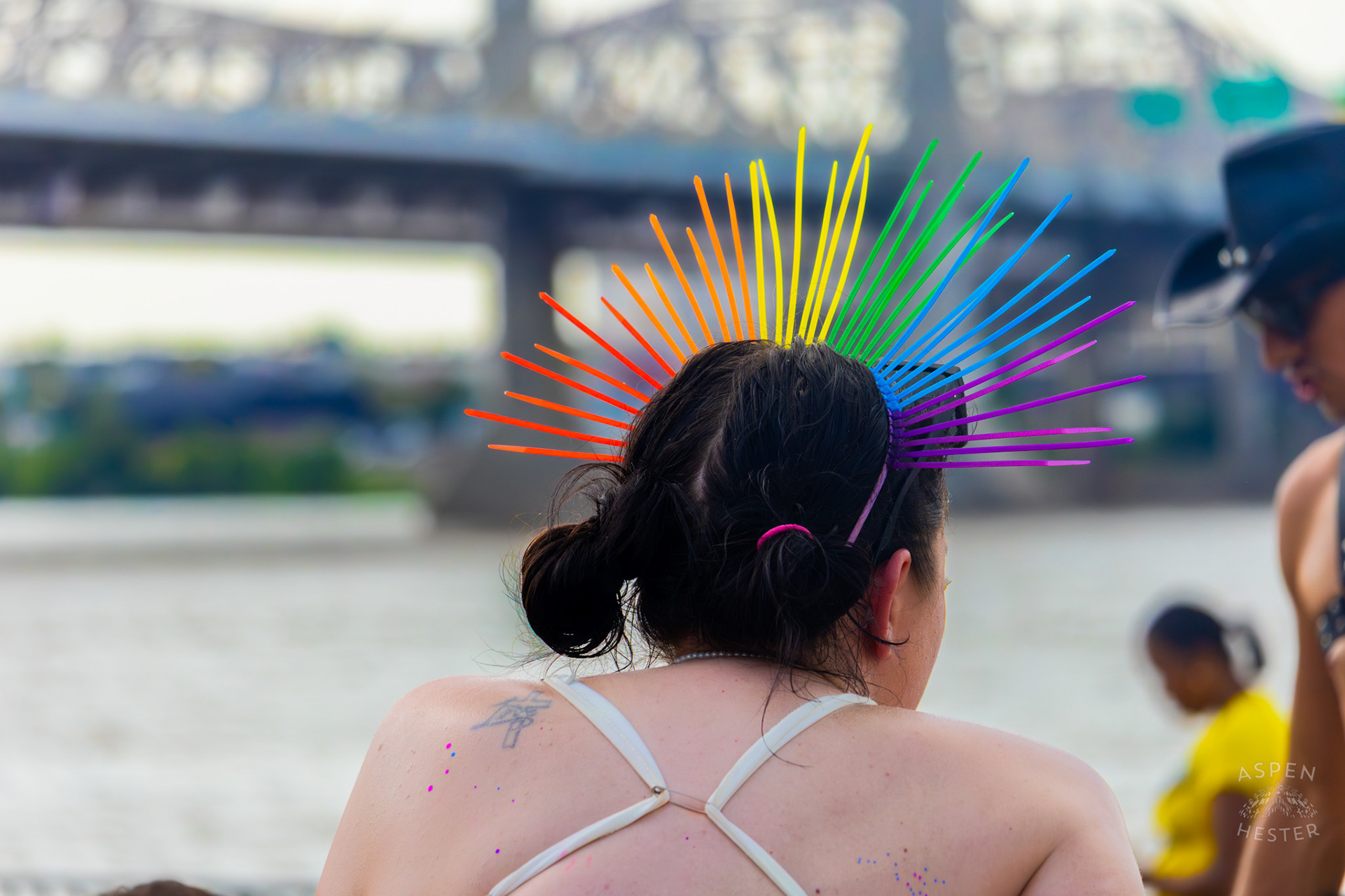 Someone Wears A Rainbow Headband While Resting by The Ohio River at Kentuckiana Pride 2025. June 21th, 2025/Aspen Hester 