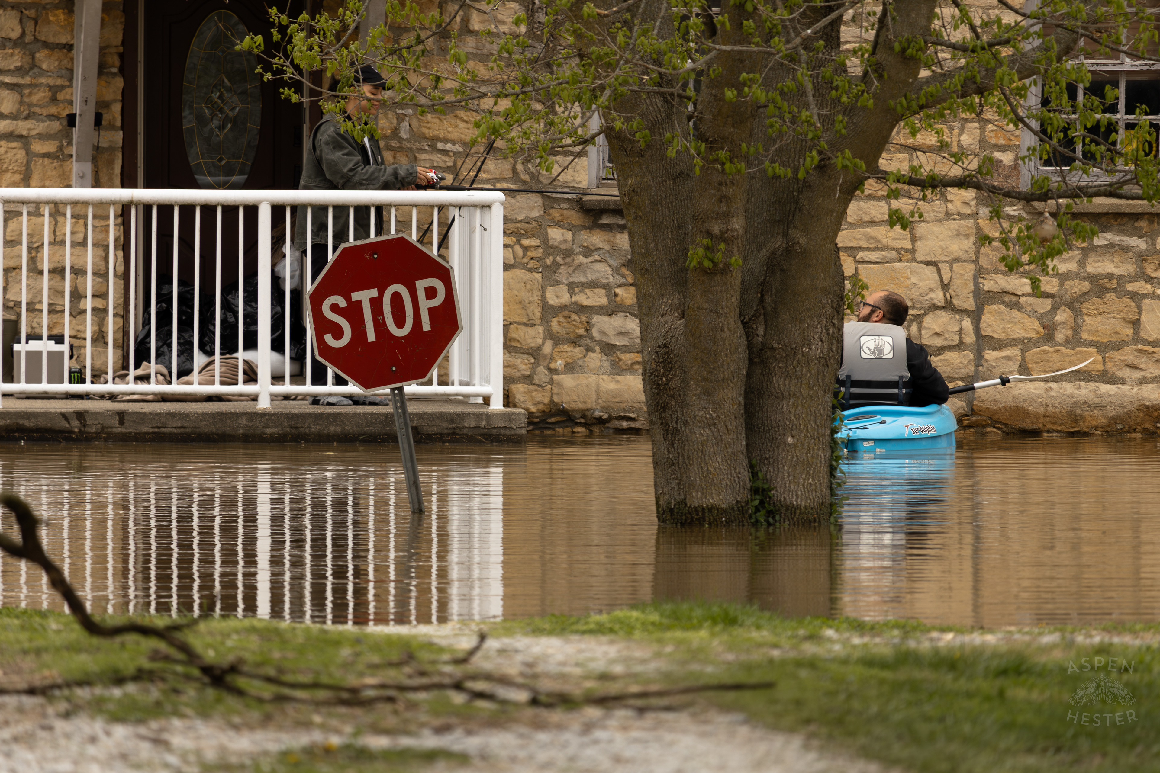 A Kayaker Paddles Up to Their Submerged Home Amid The Historic Flooding in Utica Indiana. April 9th, 2025/Aspen Hester