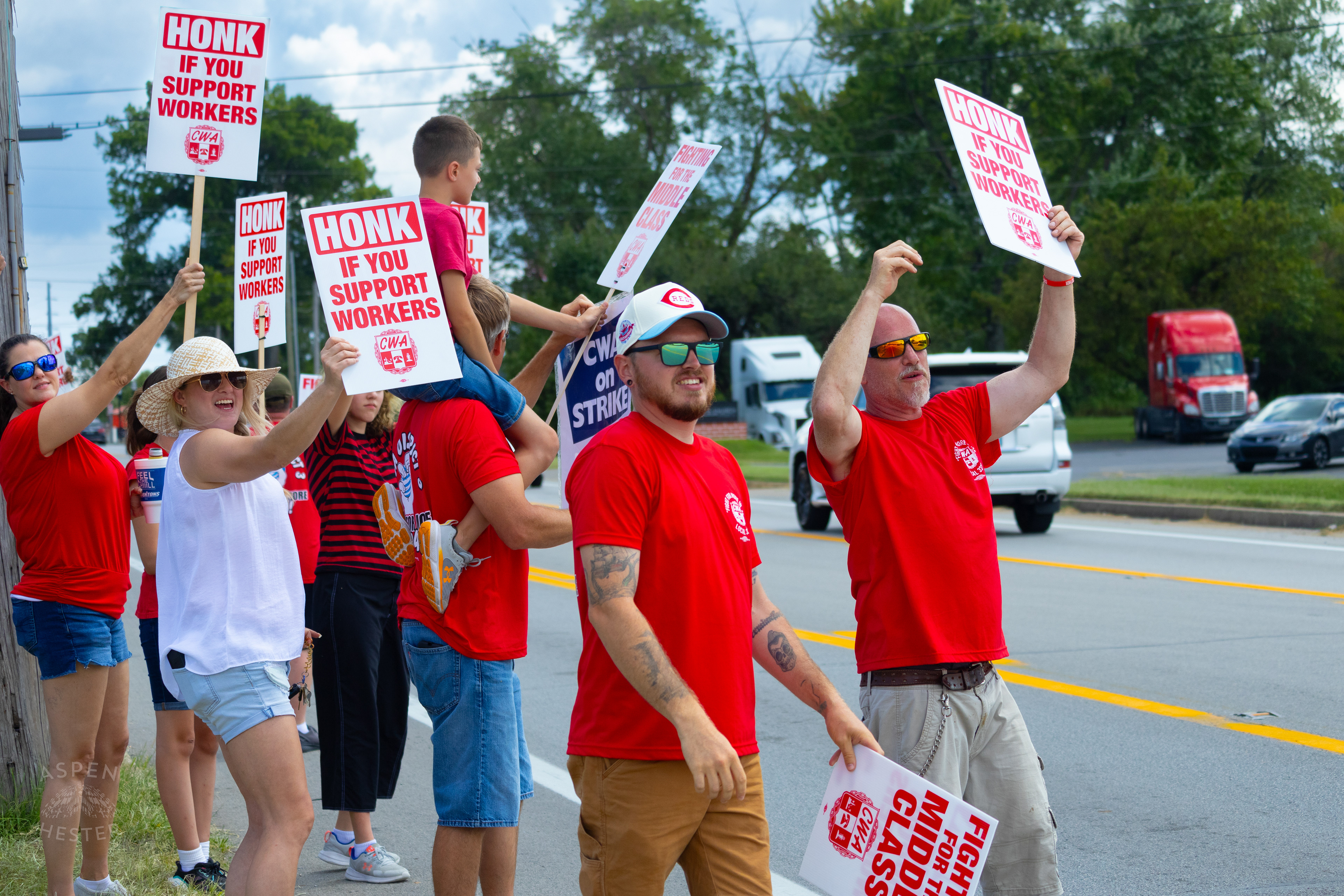 Member of The Communication Workers of America Union Hoists An Enthused Child onto Their Shoulders While Striking Against AT&T for Fair Pay and Benefits. August 18th, 2024/Aspen Hester