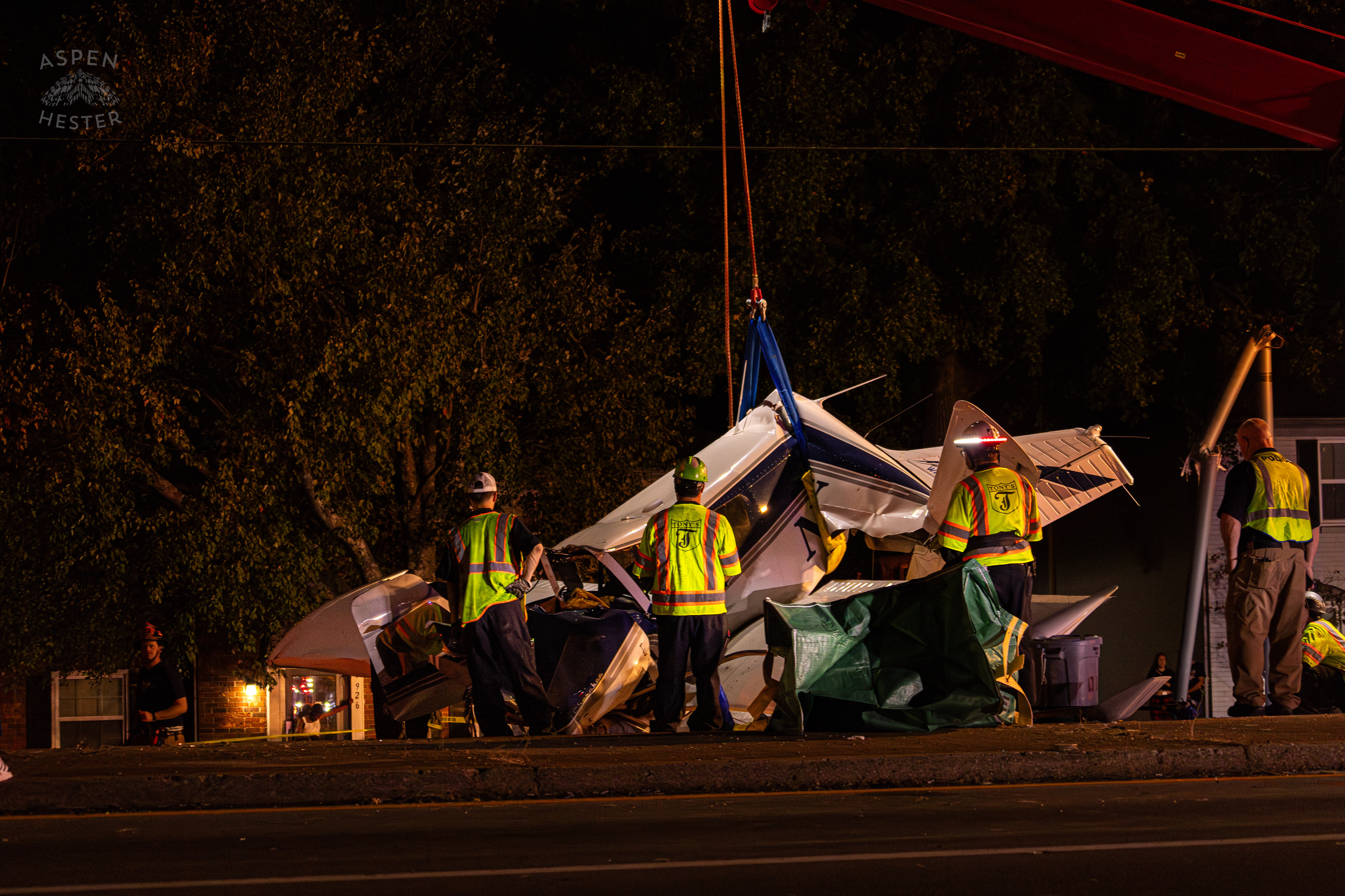 Tony’s Wreckers Crew Working to Remove The Piper Cherokee Plane from the Road after it Crash Landed, Taking Out Utility Poles, and Hitting A Car on Breckenridge Lane and Kresge Way. October 11th, 2024/Aspen Hester 