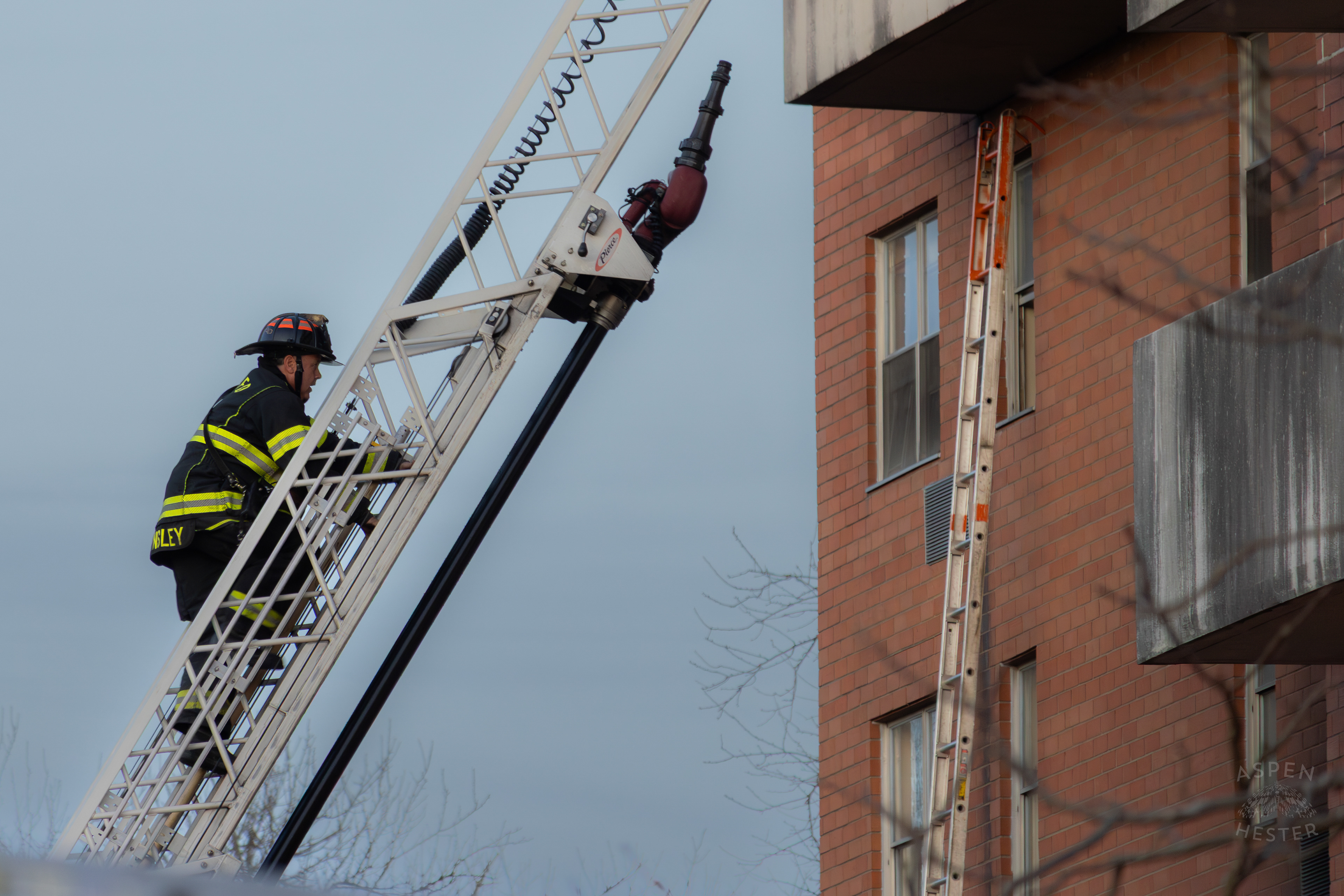 A Firefighter Climbs an Extended Ladder to Reach Victims Trapped by The Parkview Tower Fire in New Albany Indiana. March 22nd, 2025/Aspen Hester