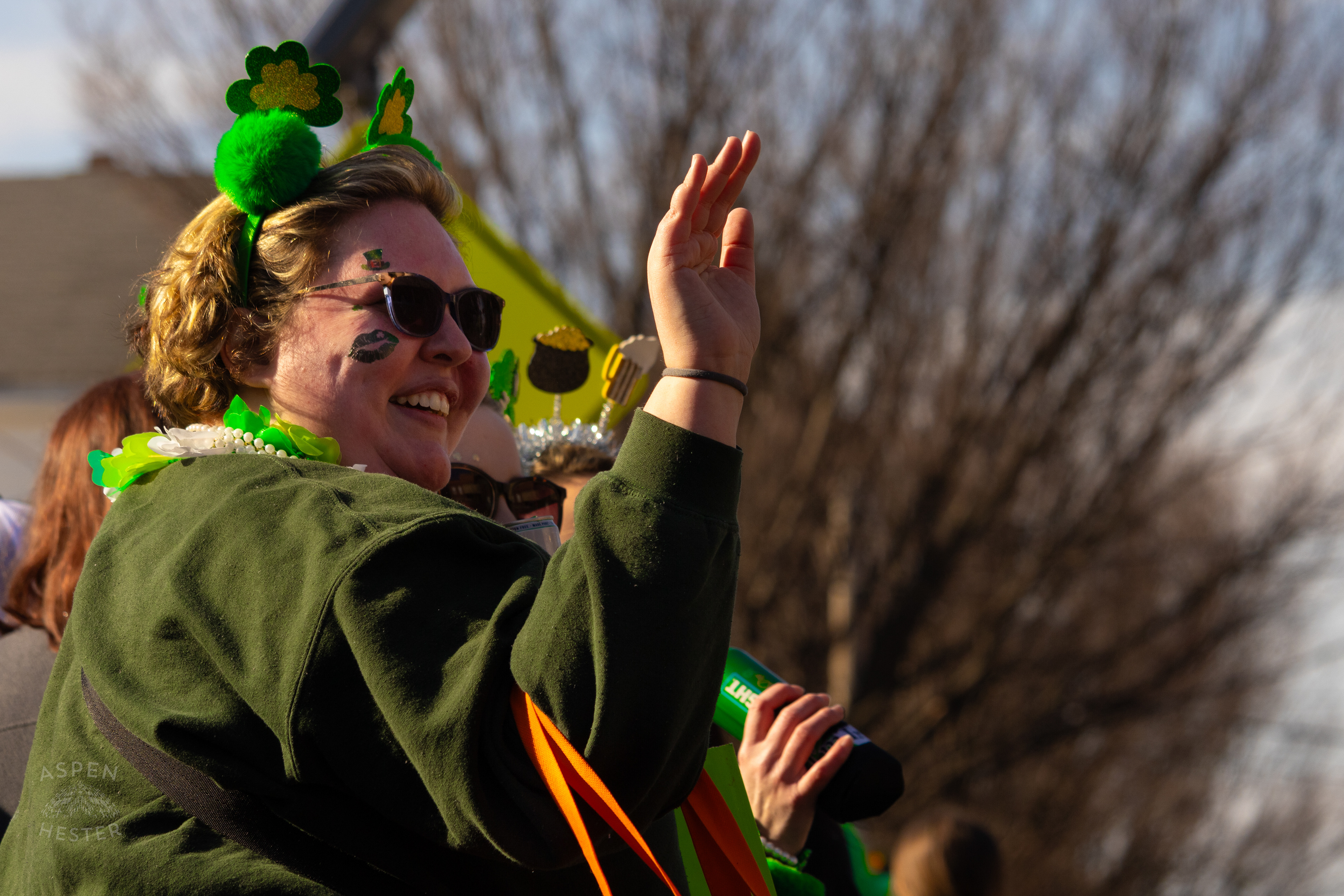 A Spectator Waves to Marchers as The 52nd Annual Saint Patrick’s Day Parade Rolls Through The Highlands. March 8th, 2025/Aspen Hester
