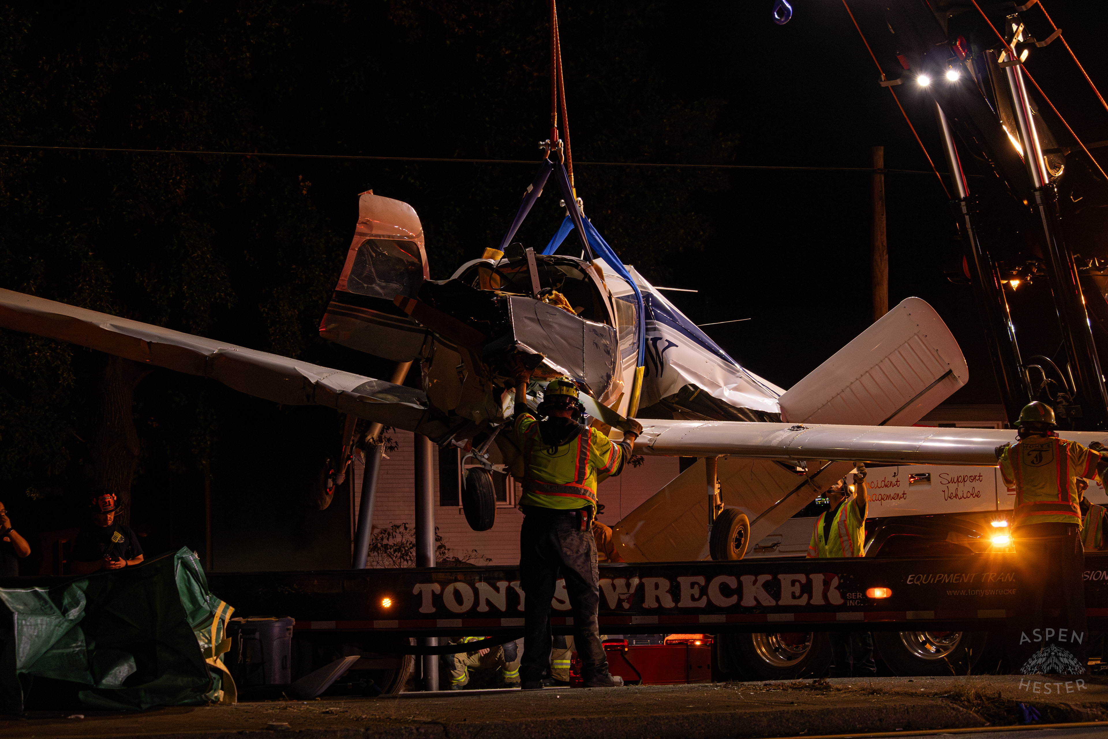 Tony’s Wreckers Crew Working to Remove The Piper Cherokee Plane from the Road after it Crash Landed, Taking Out Utility Poles, and Hitting A Car on Breckenridge Lane and Kresge Way. October 11th, 2024/Aspen Hester 