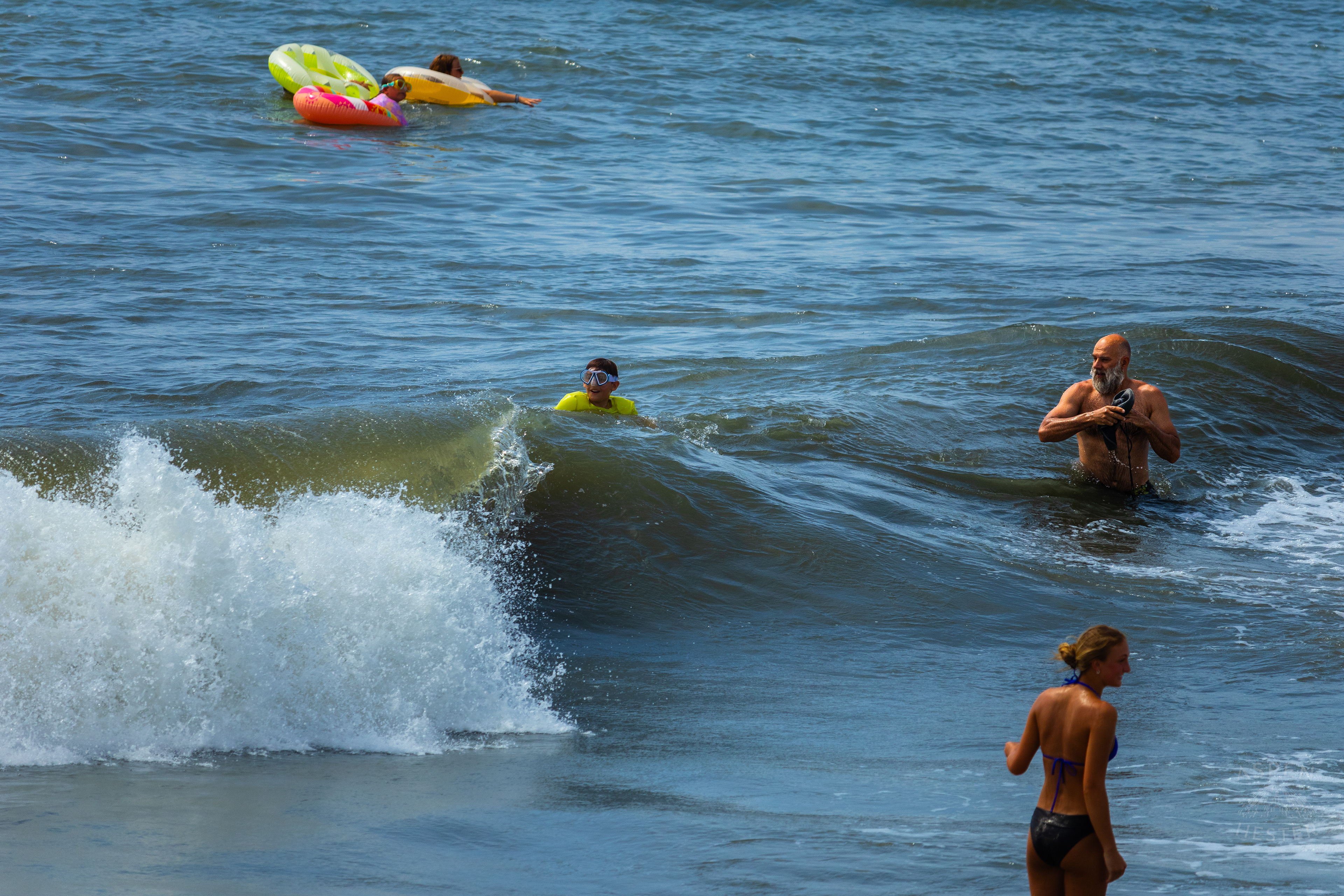 Man Wrings Out His Hat After Being Tackled by Waves on Tybee Island Georgia. June 27th, 2024/Aspen Hester