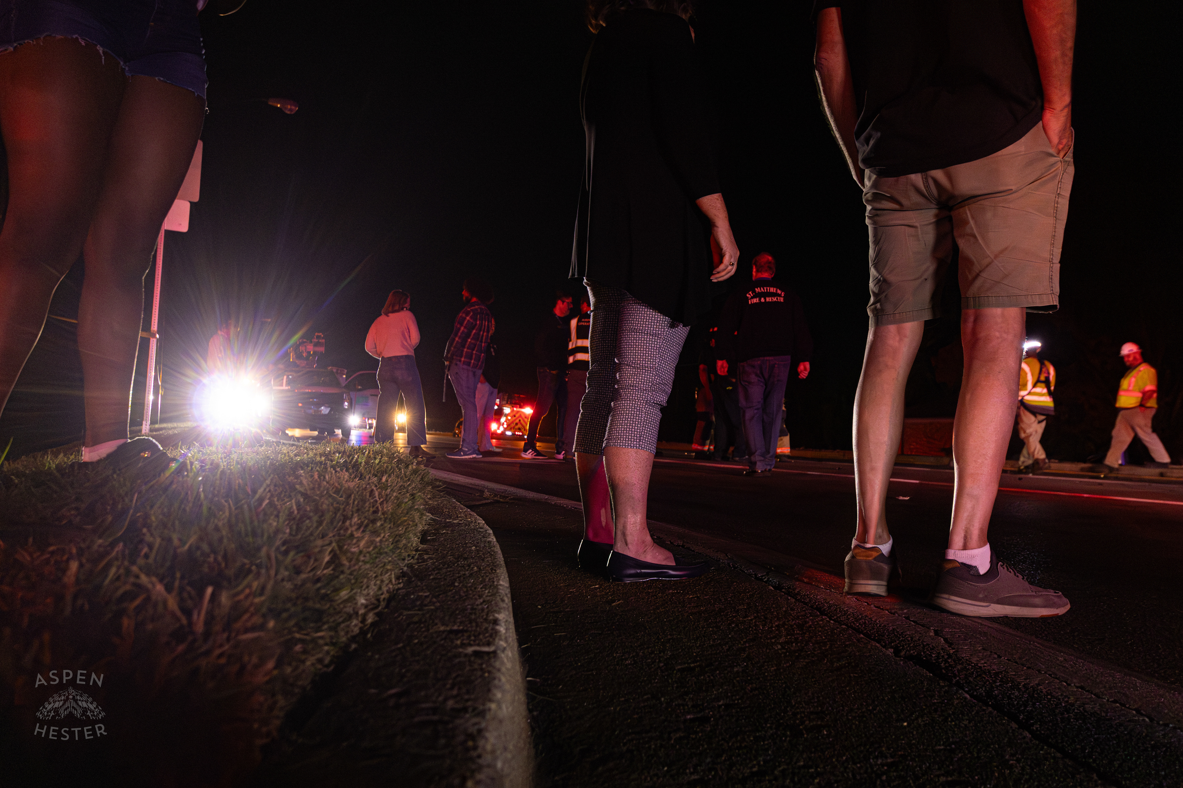 Bystanders Watching The Scene Where A Piper Cherokee Plane Crash Landed, Taking Out Utility Poles, and Hitting A Car on Breckenridge Lane and Kresge Way. October 11th, 2024/Aspen Hester 