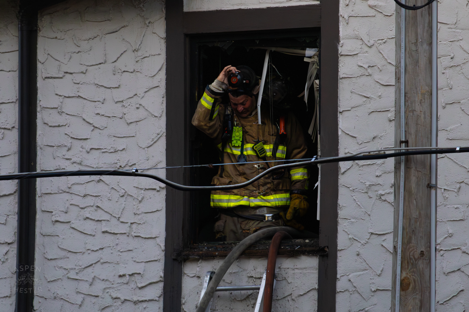 Louisville Firefighter Looking Out of A Burning Building on The Corner of 2nd and Oak Street. June 7th, 2024/Aspen Hester