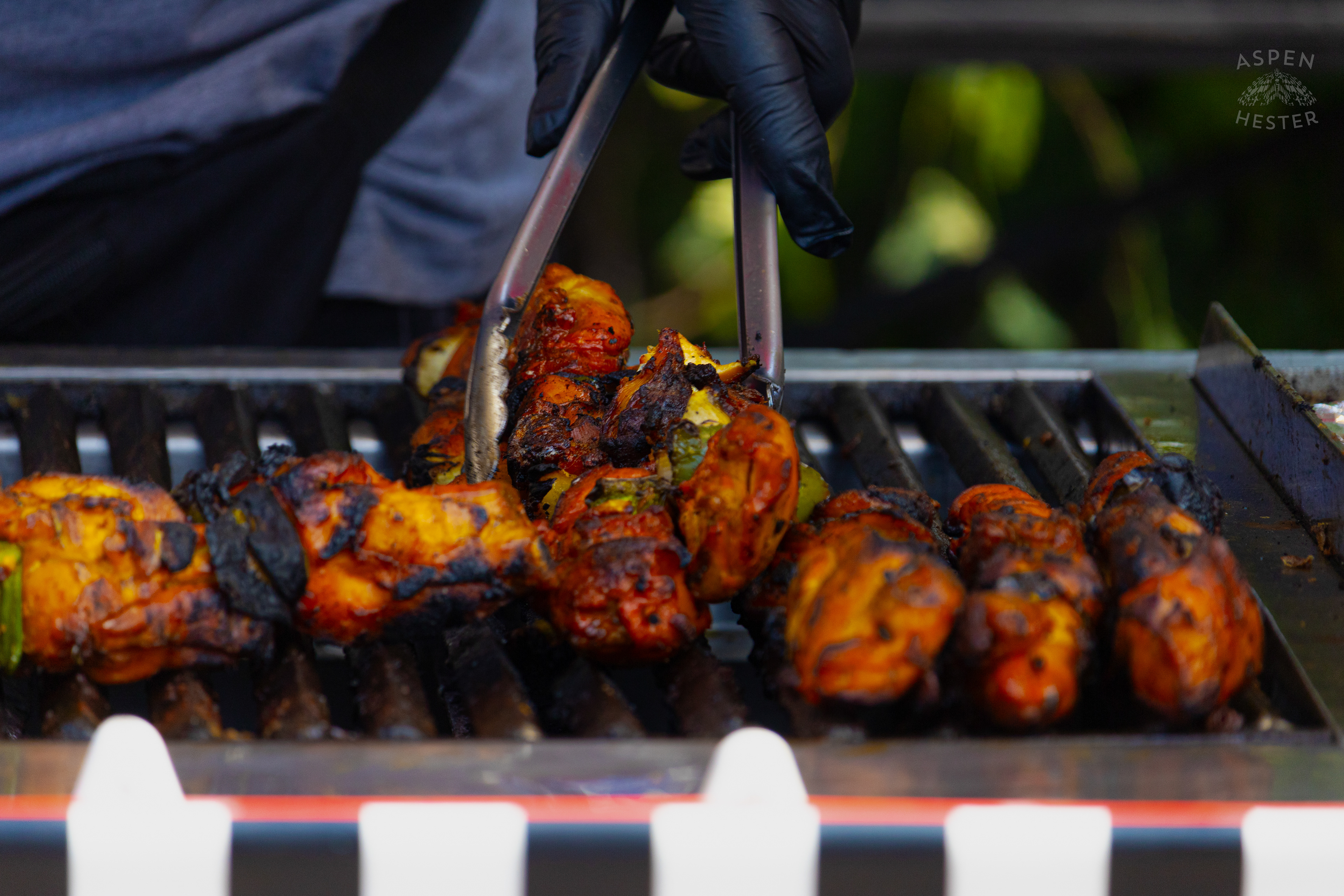 Chef at Enrique's Place Latin Grill Preparing Kabobs for The Opening Day of The 22nd Annual WorldFest. August 30th, 2024. Aspen Hester