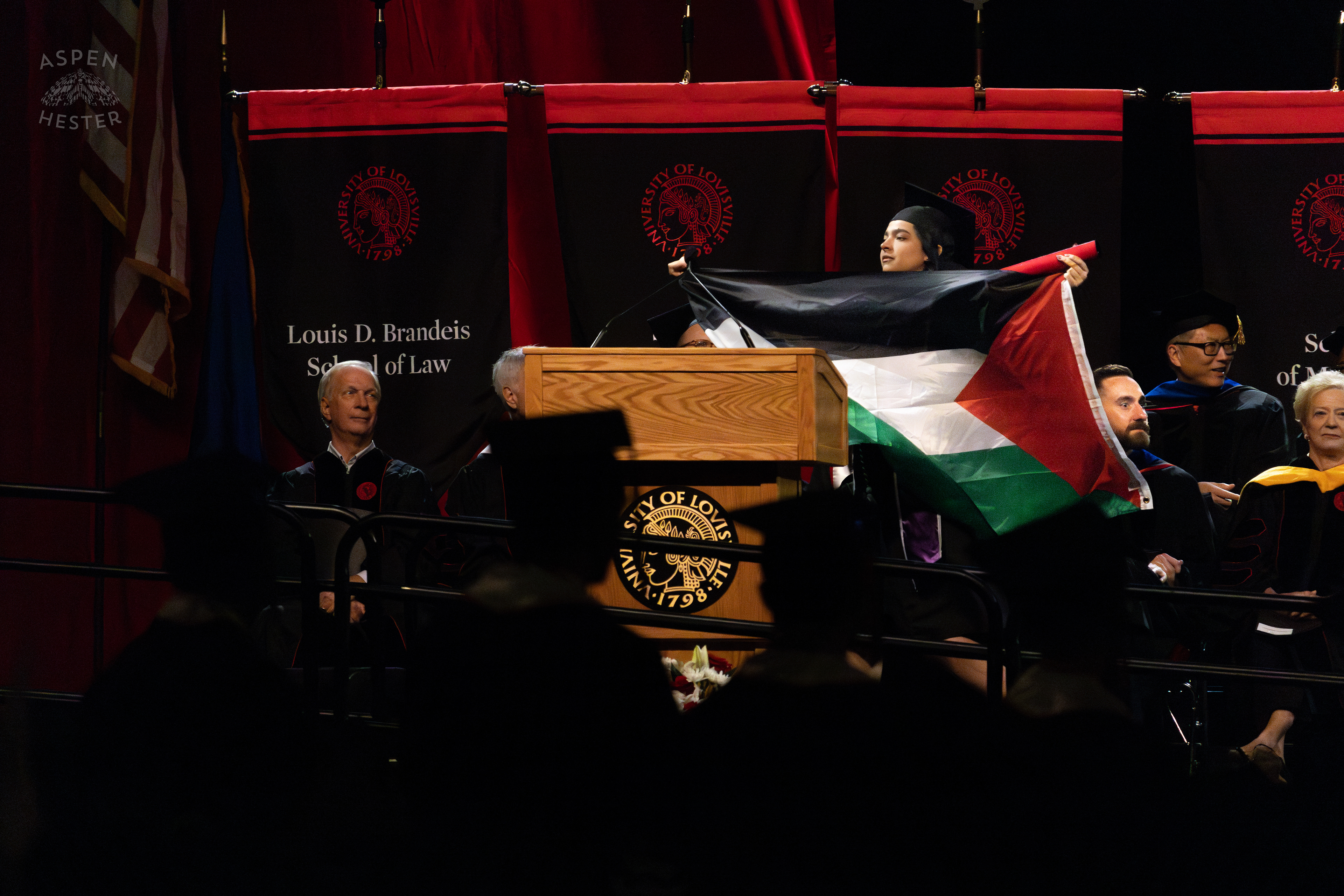 Student Flies The Palestinian Flag as They Walk Across The Stage at UofL's 2024 Spring Graduation. May 11th, 2024/Aspen Hester