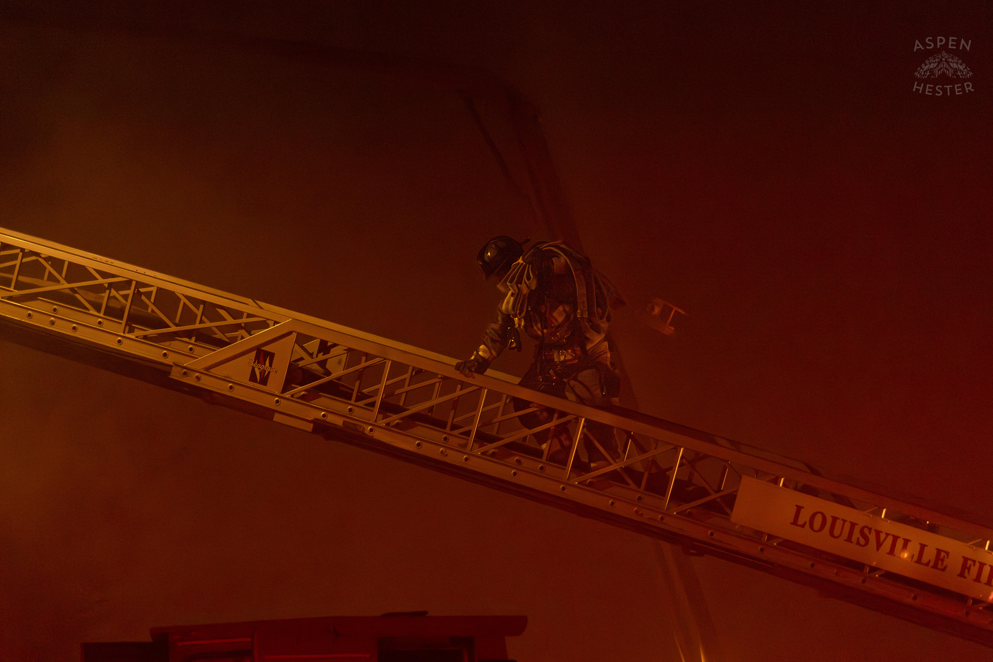 Firefighter Climbing an Aerial Carrying Hoses to Battle the Massive 3 Alarm Blaze Engulfing The Vacant St. Paul's German Evangelical Church on East Broadway. October 9th, 2024/Aspen Hester