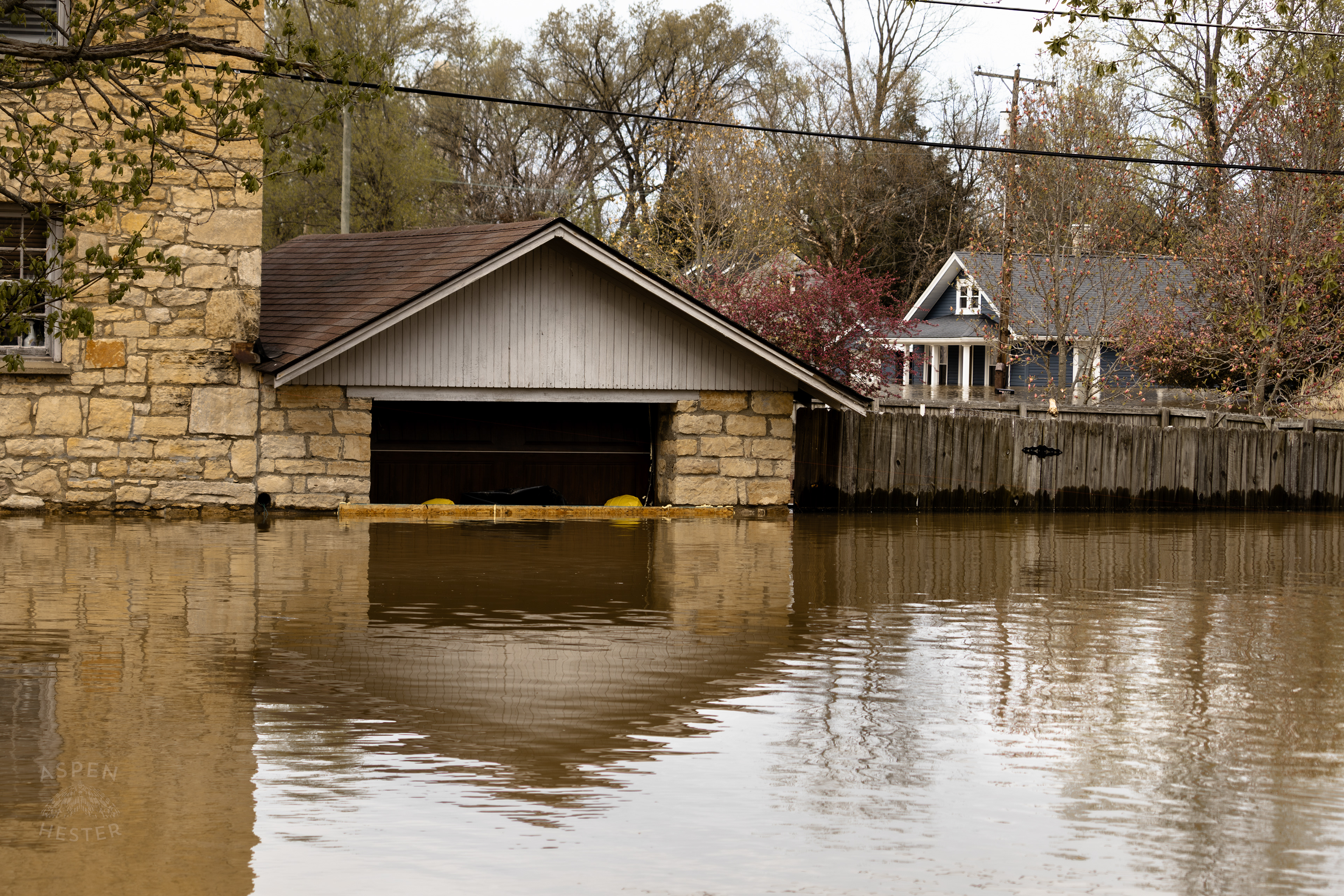 Water Creeping Halfway Up A Garage Door As The Ohio River Reaches Its Crest Amid The Historic Flooding in Utica Indiana. April 9th, 2025/Aspen Hester