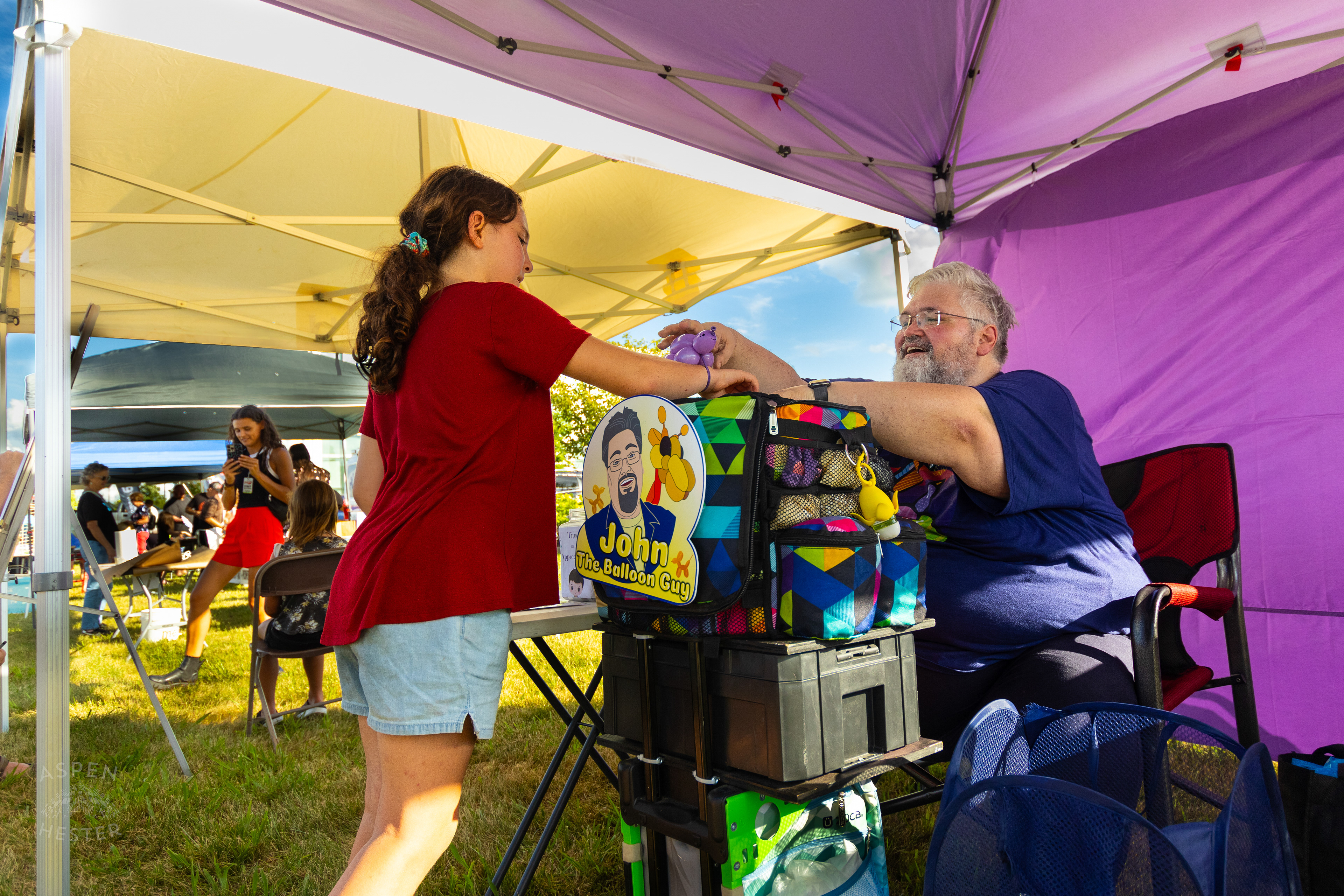 John the Balloon Guy Makes a Balloon Bracelet at Play America with The Louisville Orchestra. July 5th, 2024/Aspen Hester