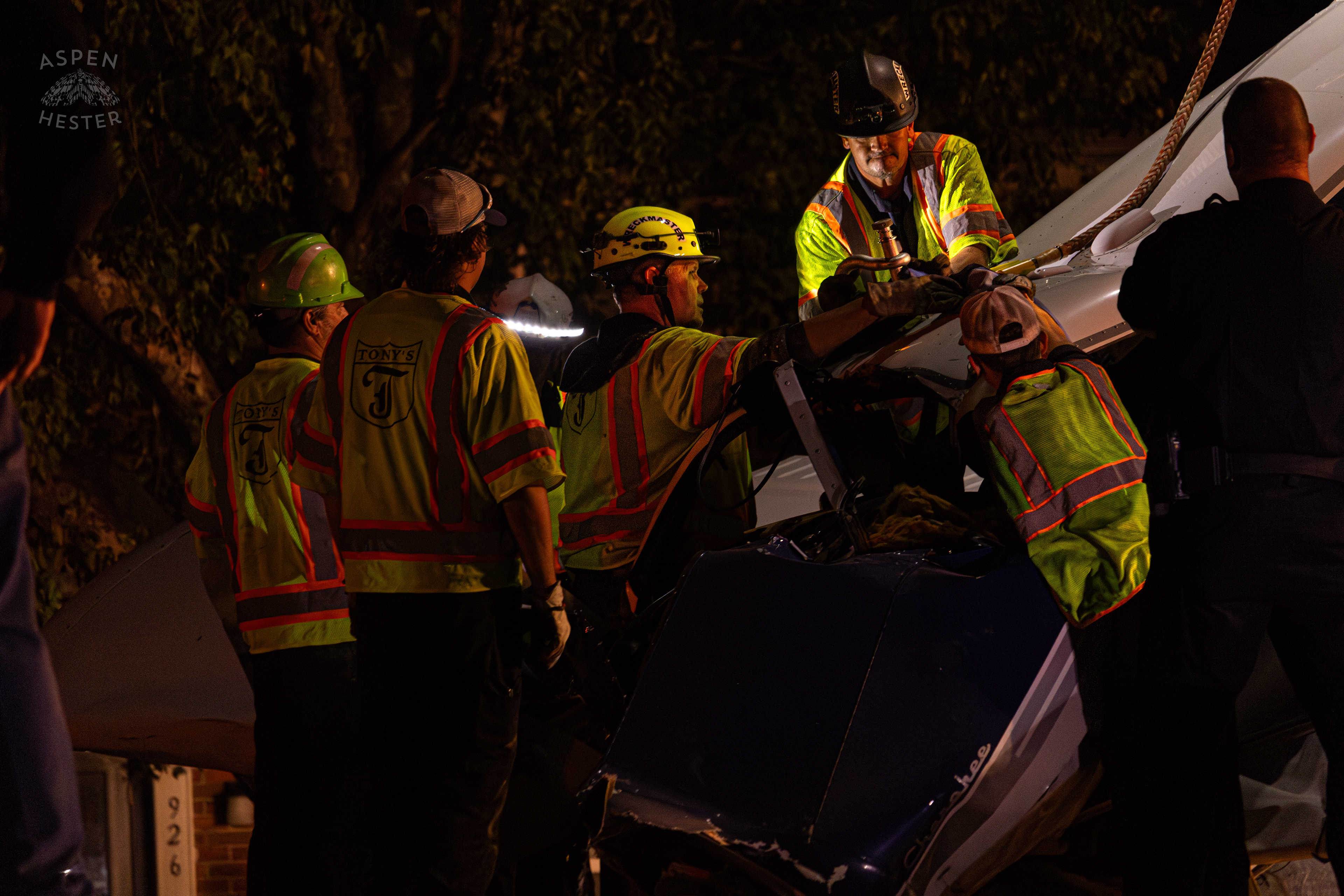 Tony’s Wreckers Crew Working to Remove The Piper Cherokee Plane from the Road after it Crash Landed, Taking Out Utility Poles, and Hitting A Car on Breckenridge Lane and Kresge Way. October 11th, 2024/Aspen Hester 