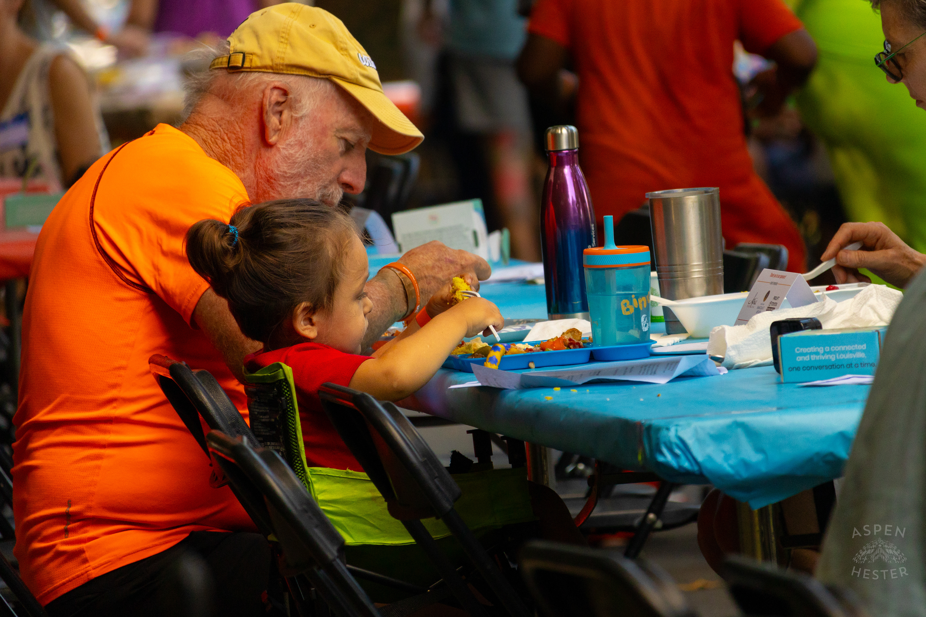 A Young Child Feeds Themself from The Big Table at Iroquois Park. September 15th, 2024/Aspen Hester
