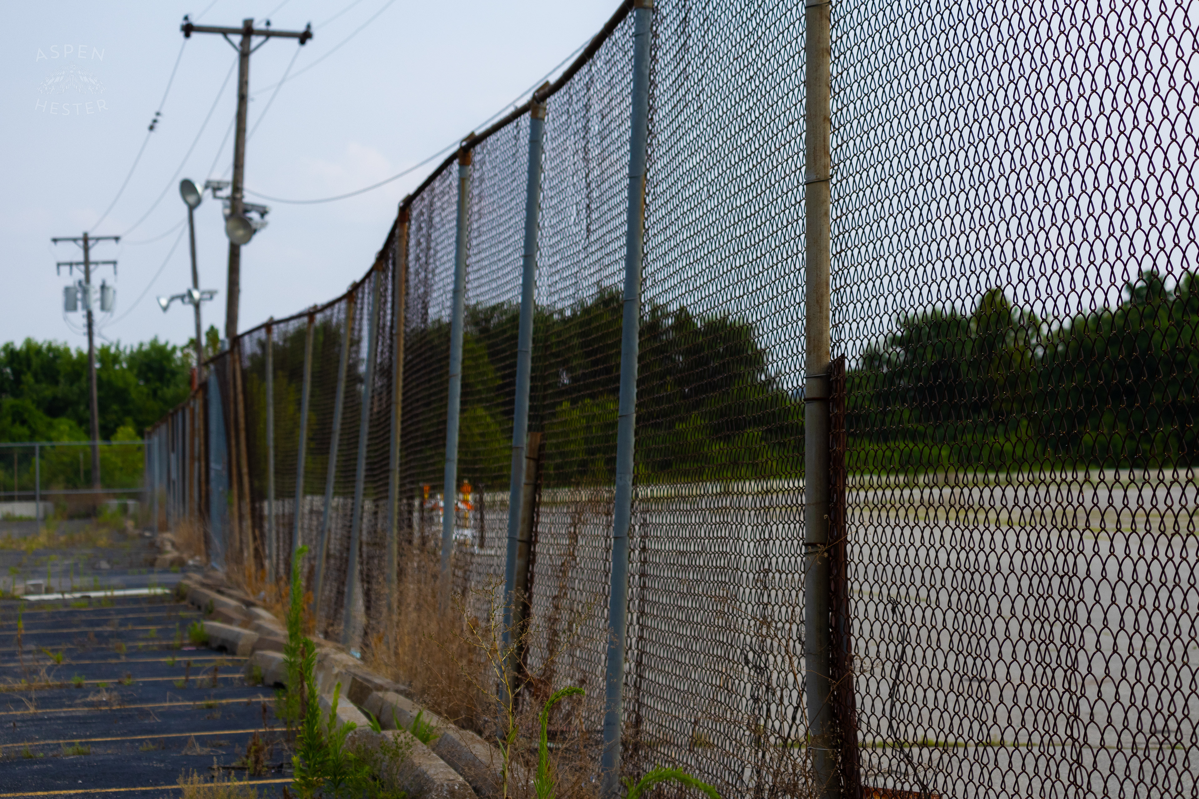 The Chain Link Fence Surrounding the Abandoned Jeffboat Shipyard. July 26th, 2024/Aspen Hester