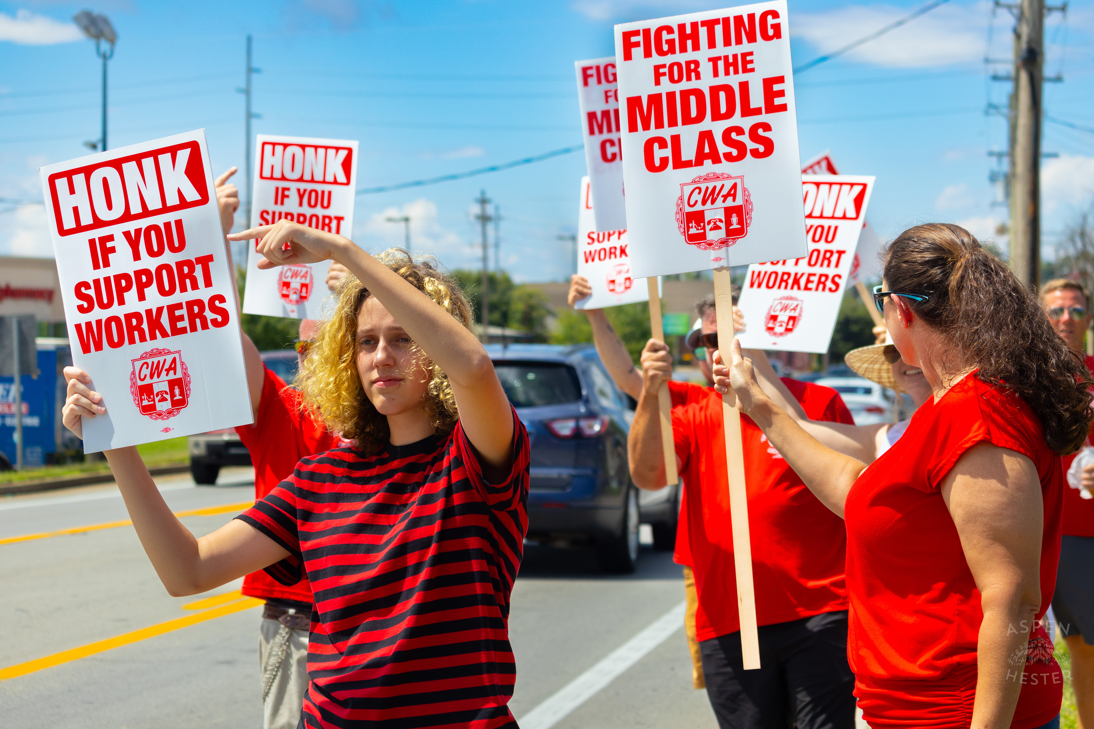 Picketer Encourages Cars to Honk in Support of The Communication Workers of America Union Strike Against AT&T for Fair Pay and Benefits. August 18th, 2024/Aspen Hester