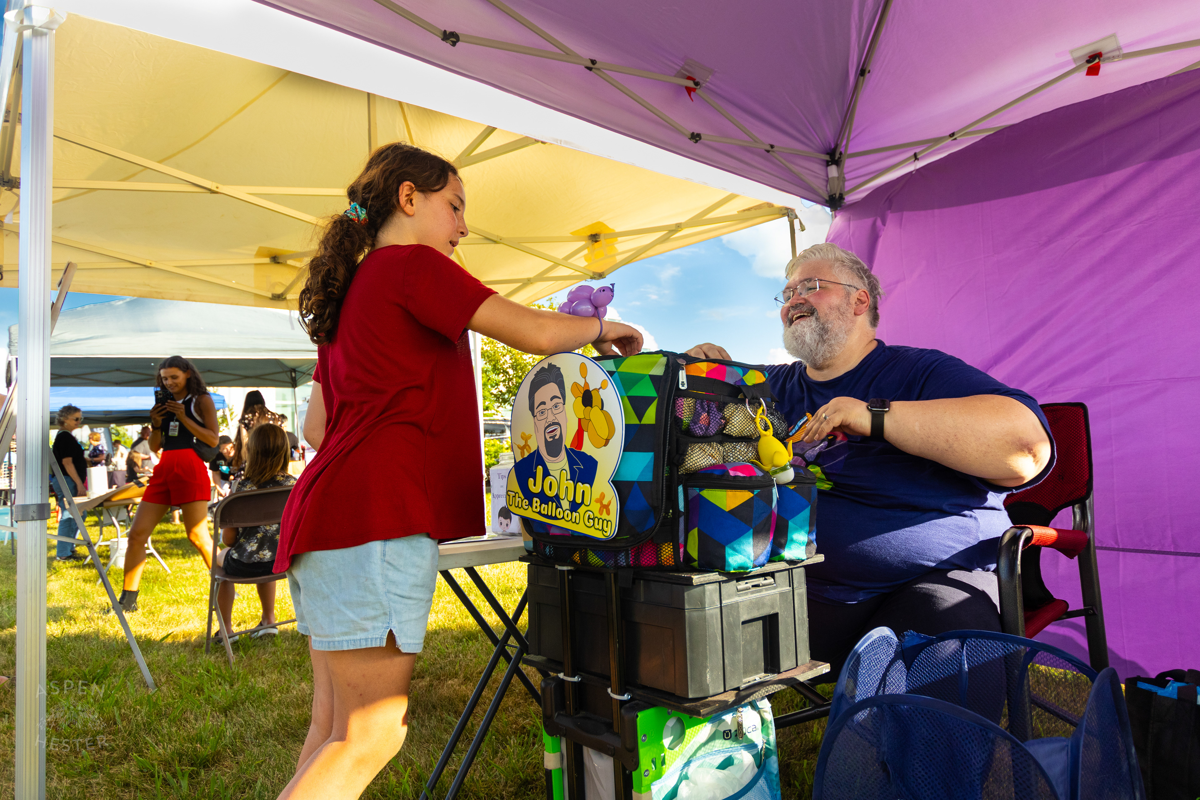 John the Balloon Guy Makes a Balloon Bracelet at Play America with The Louisville Orchestra. July 5th, 2024/Aspen Hester
