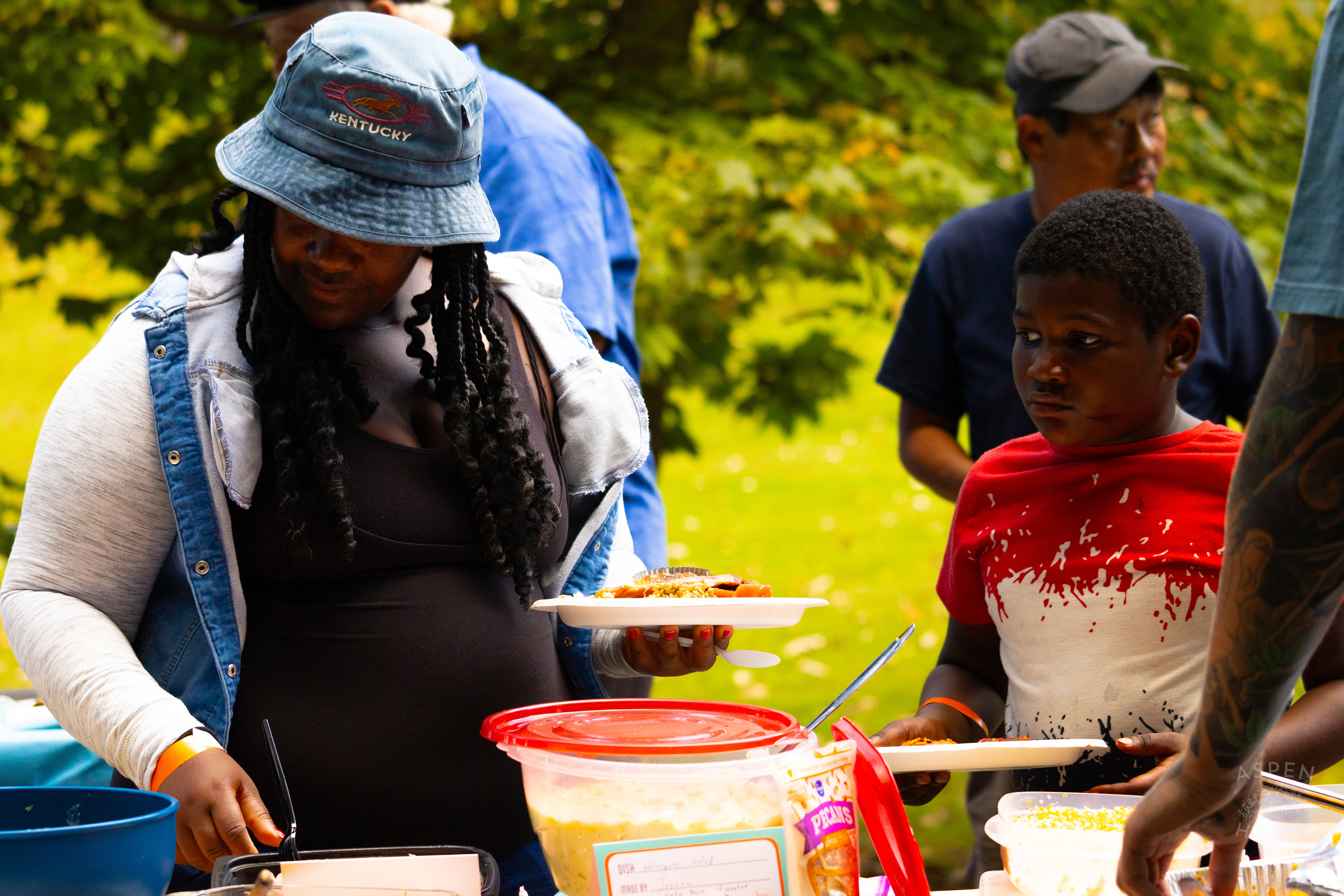 Community Members Filling Their Plates from The Big Table at Iroquois Park. September 15th, 2024/Aspen Hester