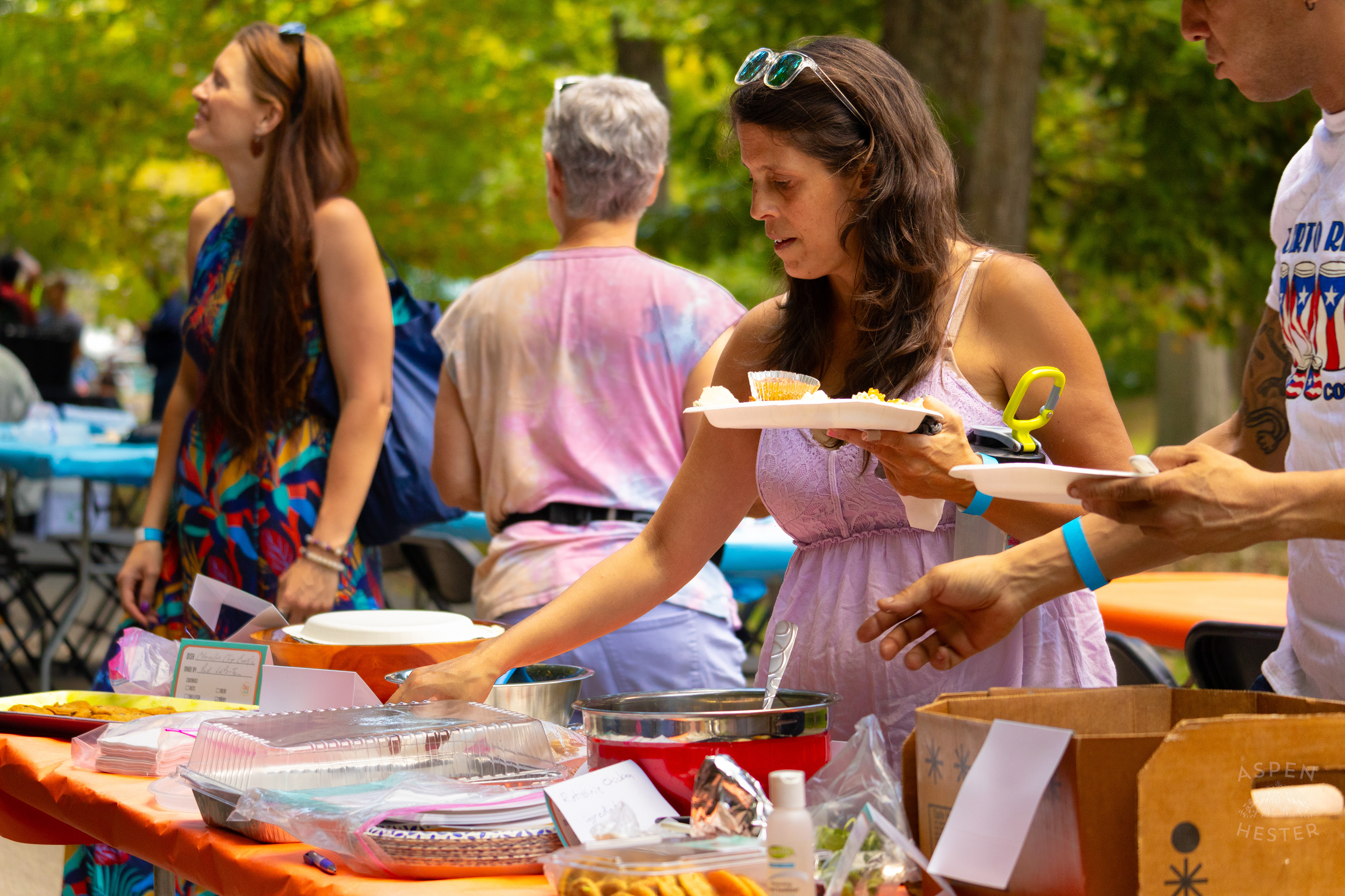 Community Members Filling Their Plates from The Big Table at Iroquois Park. September 15th, 2024/Aspen Hester