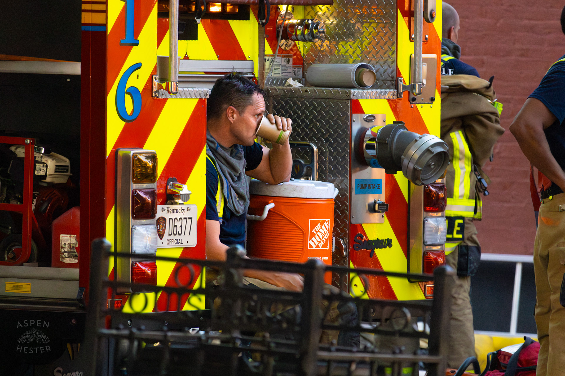 Louisville Firefighter Rests After Battling Flames on The Corner of 2nd and Oak Street. June 7th, 2024/Aspen Hester