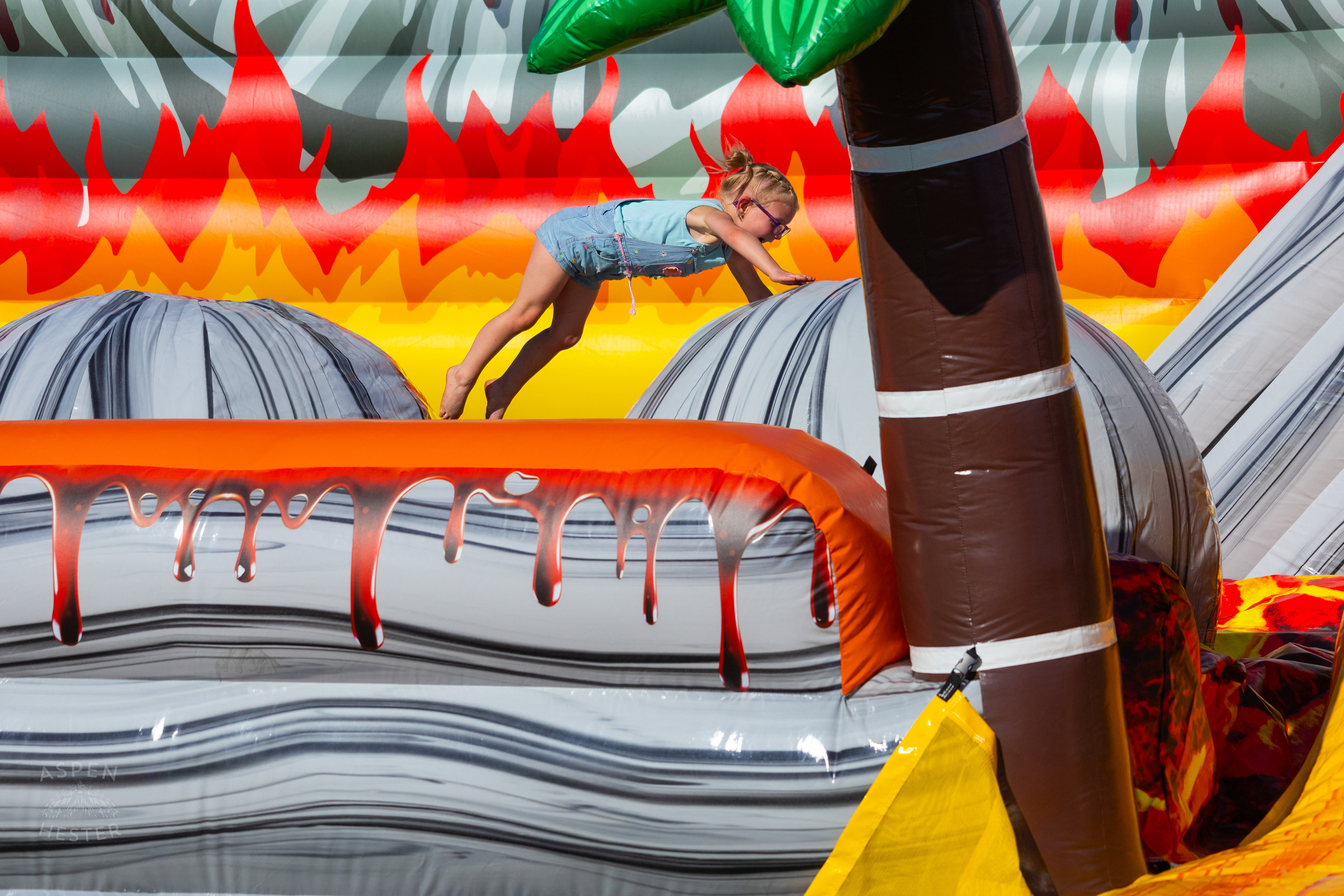 Kid Attempting to Make it Across "The Floor is Lava" at Play America with The Louisville Orchestra. July 5th, 2024/Aspen Hester