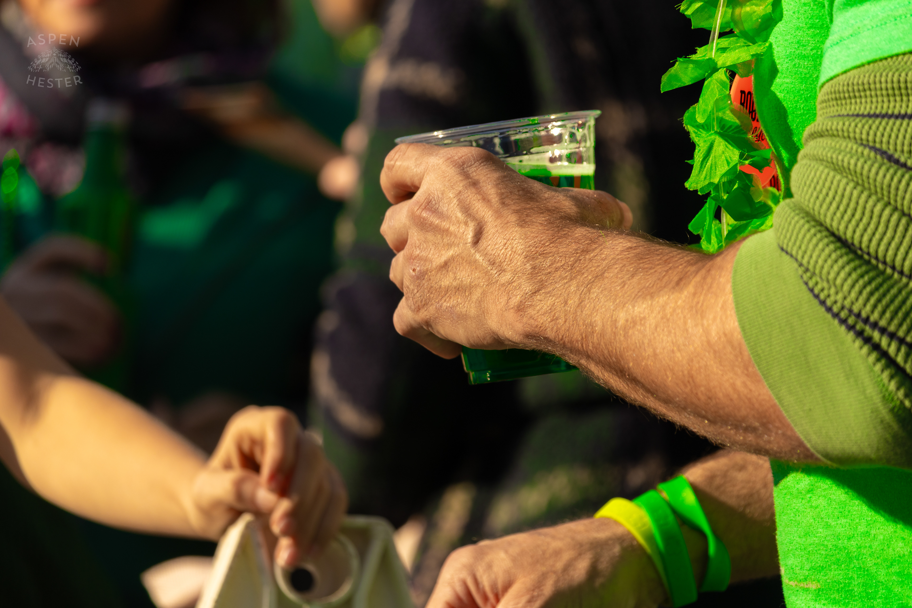 A Spectator Drinks Green Saint Paddy’s Beer as The 52nd Annual Saint Patrick’s Day Parade Rolls Through The Highlands. March 8th, 2025/Aspen Hester