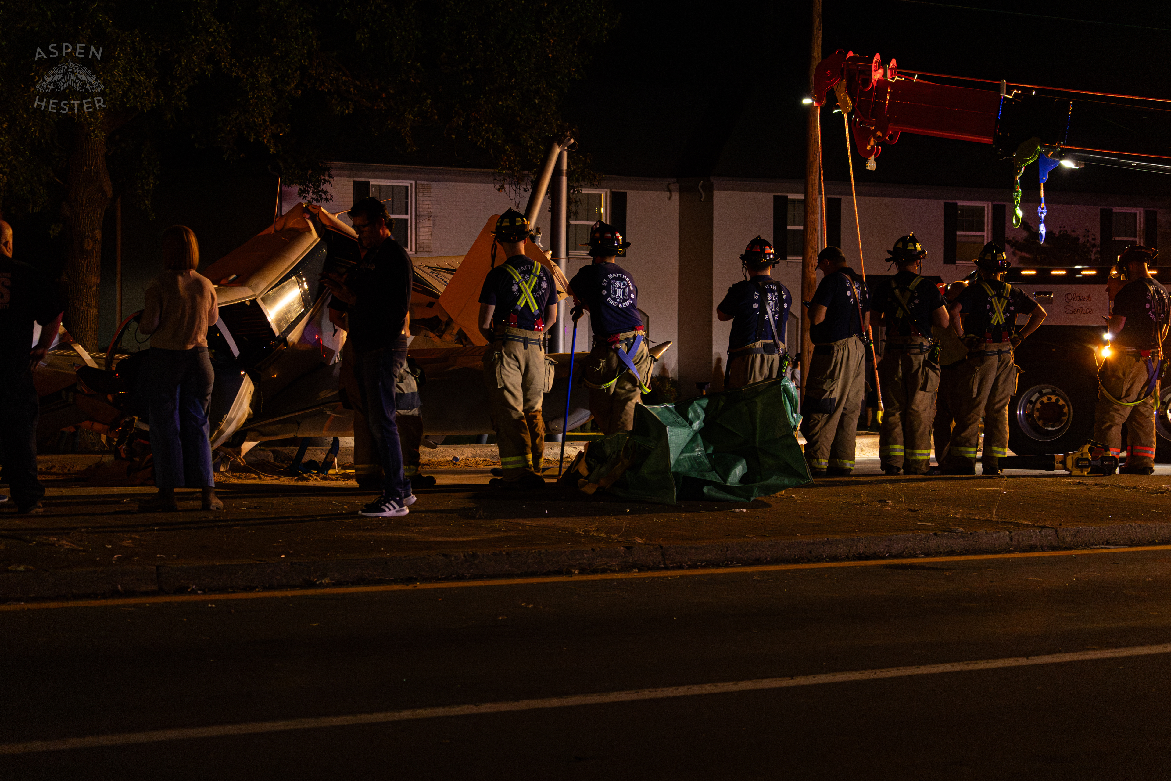 St. Matthews Firefighters Watching Over The Scene Where A Piper Cherokee Plane Crash Landed, Taking Out Utility Poles, and Hitting A Car on Breckenridge Lane and Kresge Way. October 11th, 2024/Aspen Hester 