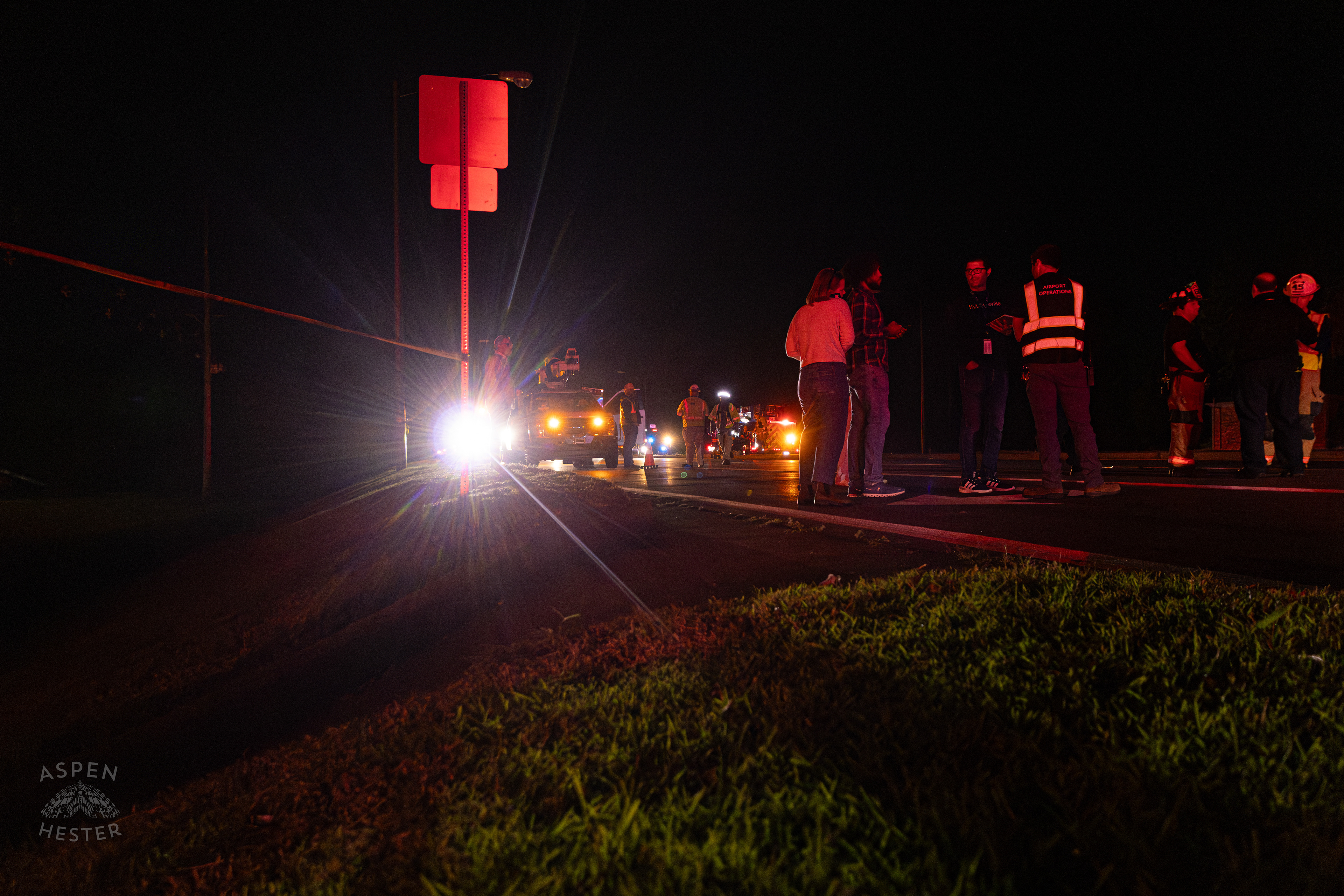 Airport Authorities Watching Over The Scene Where A Piper Cherokee Plane Crash Landed, Taking Out Utility Poles, and Hitting A Car on Breckenridge Lane and Kresge Way. October 11th, 2024/Aspen Hester 