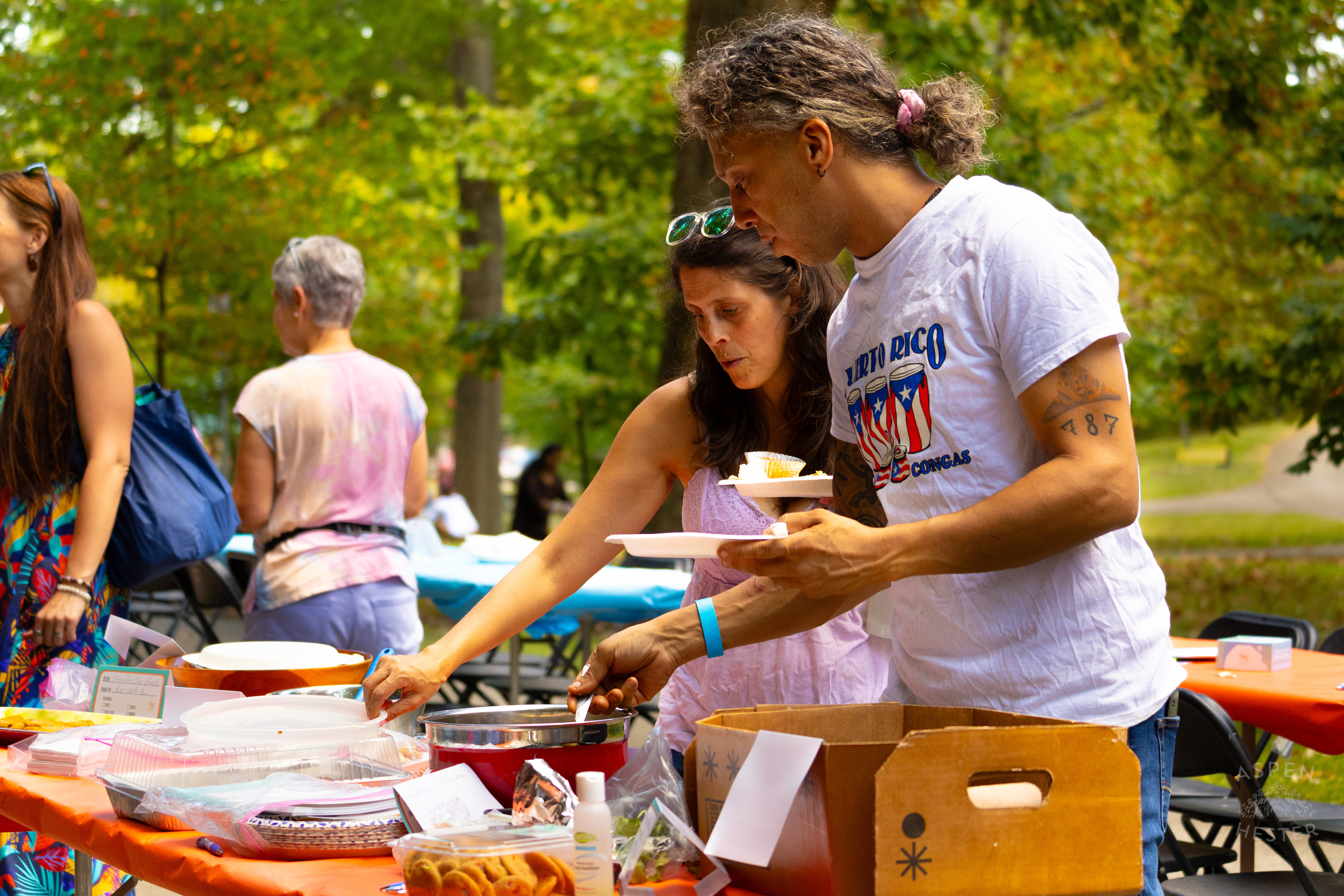 Community Members Filling Their Plates from The Big Table at Iroquois Park. September 15th, 2024/Aspen Hester