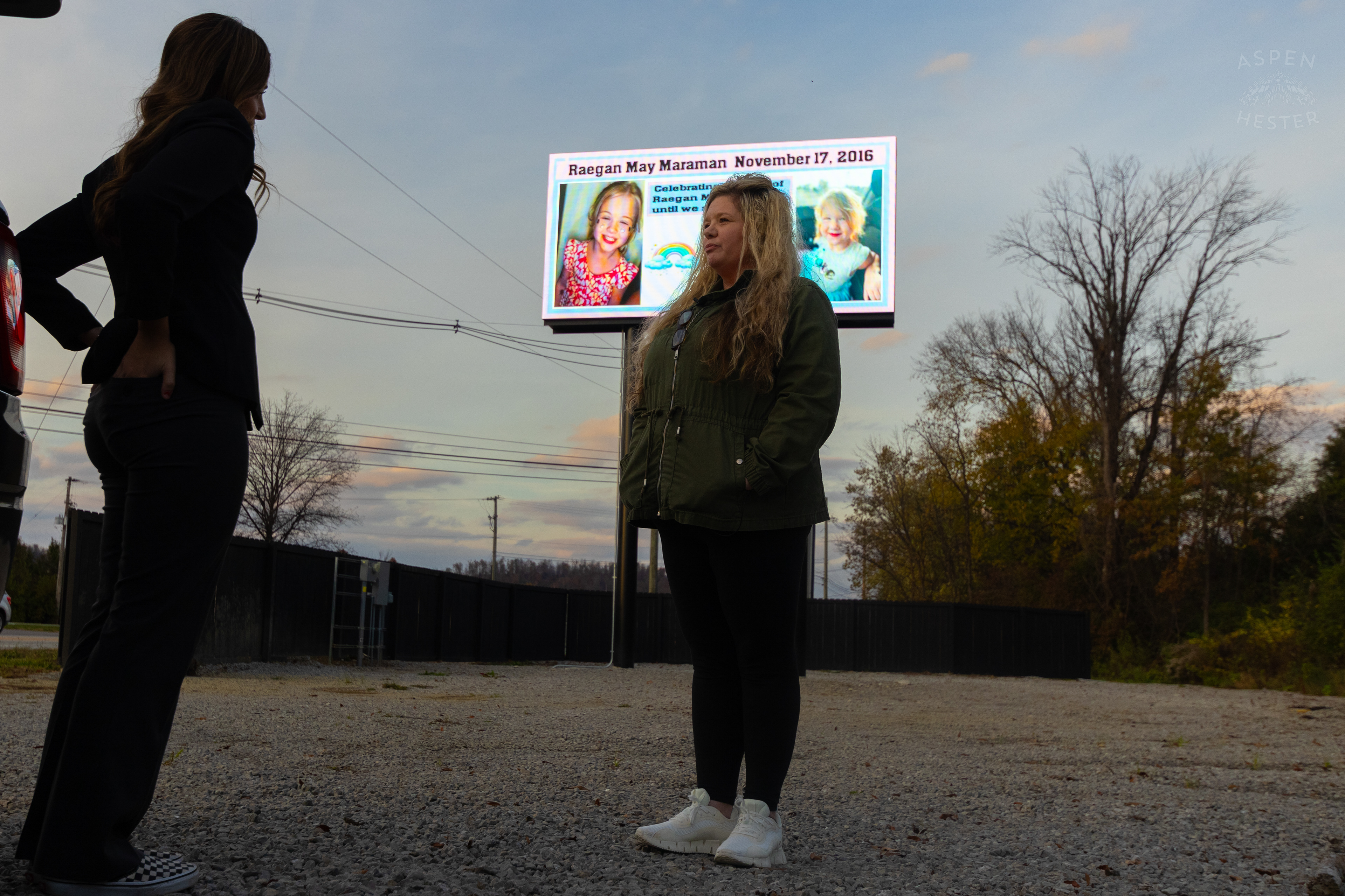 WHAS-11’s Alexandra Goldberg Talking to Tina Swann as She Stands In Front of The Billboard She Pays for and Designs in Remembrance Every Year on Her Granddaughter Raegan Maramans Birthday so That The Community of Lebanon Junction Never Forgets Her Tragic House Fire Death. November 17th, 2024/Aspen Hester