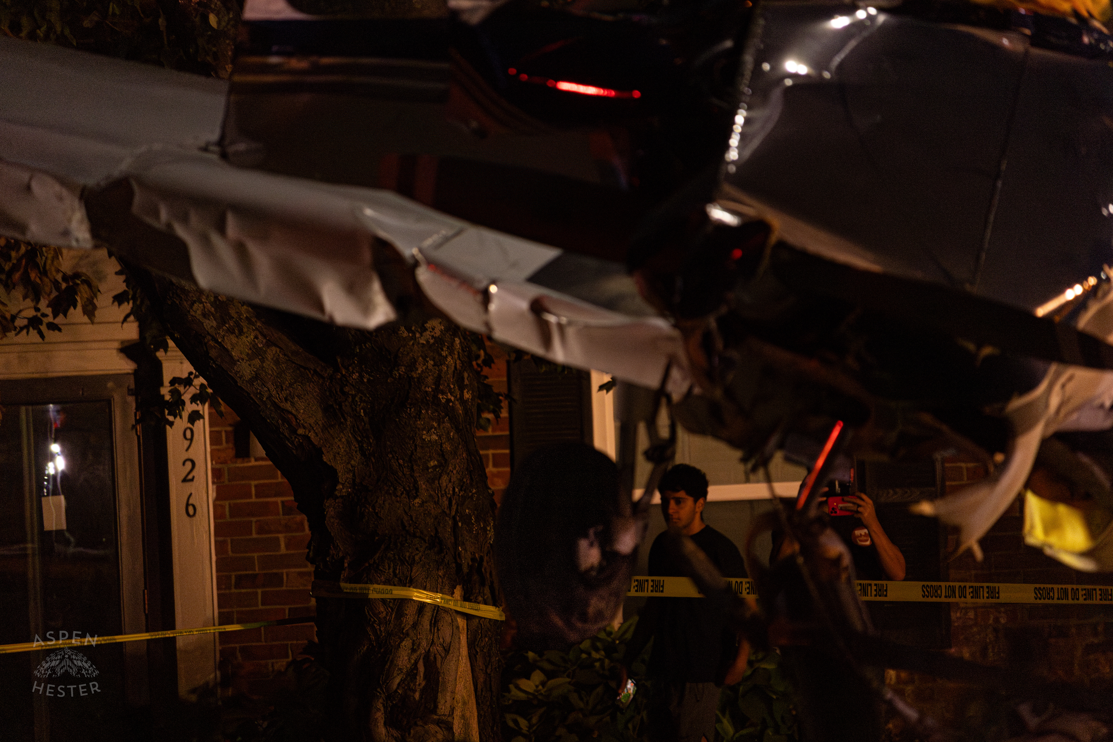 Onlookers Watching as Tony's Wreckers Crew Works to Remove The Piper Cherokee Plane from the Road after it Crash Landed, Taking Out Utility Poles, and Hitting A Car on Breckenridge Lane and Kresge Way. October 11th, 2024/Aspen Hester