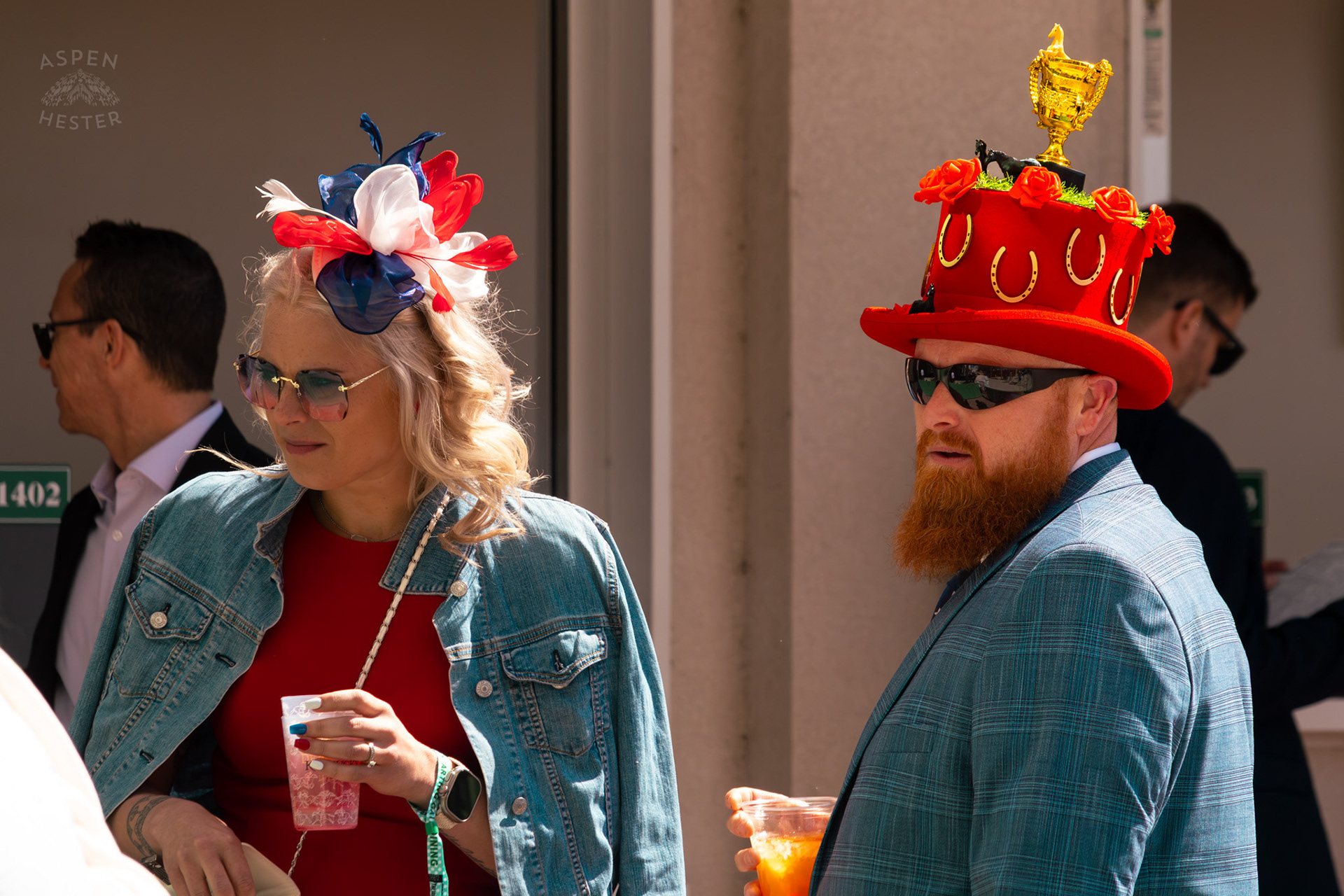 A Ginger Sports A Derby Day Trophy Top Hat in Rose Red Near The Churchill Downs Grand Stands During Thurby. April 30th, 2026/Aspen Hester
