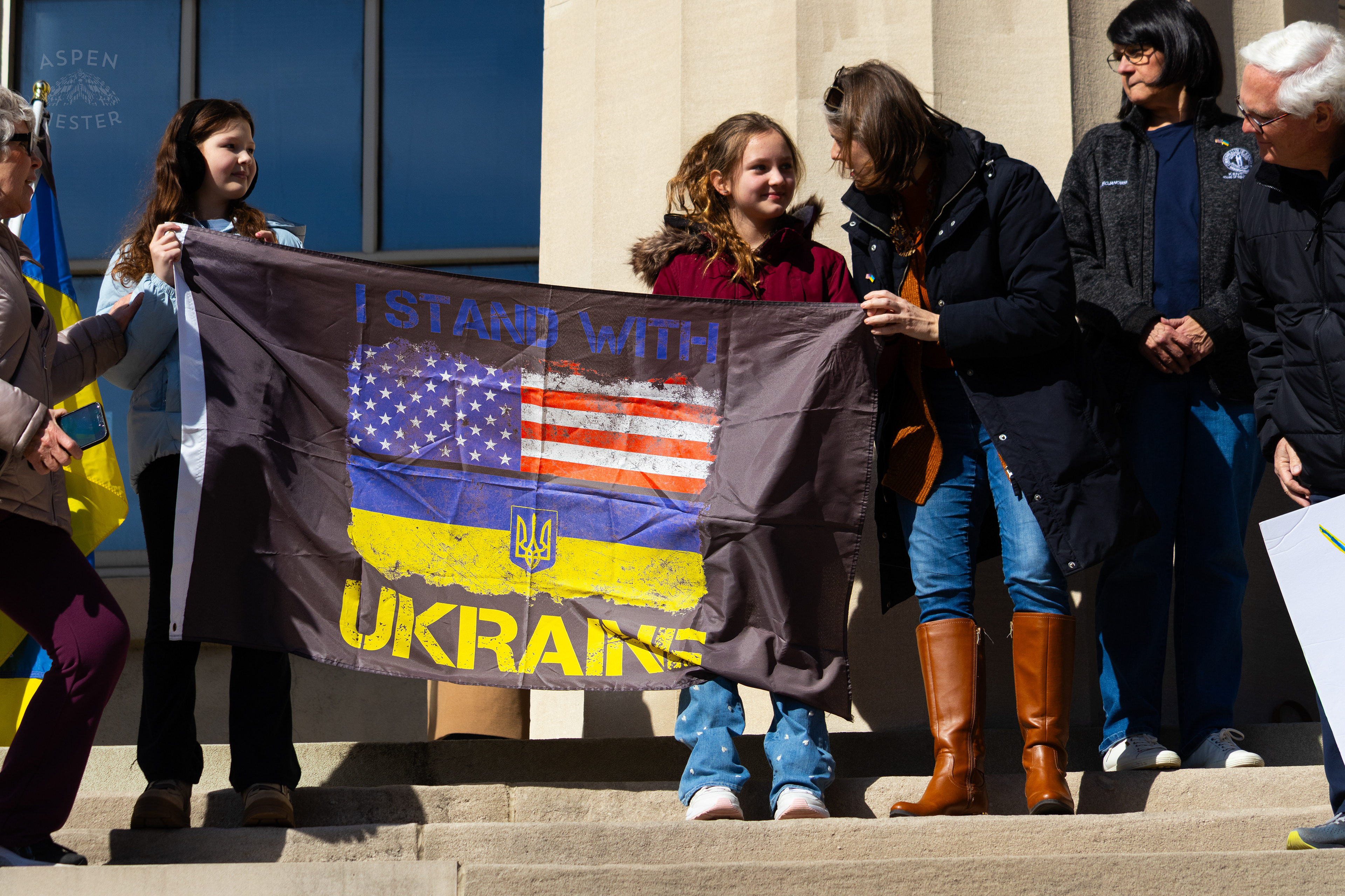 Two Ukrainian Louisvillians Children Proudly Hold Up A Flag That Says “I Stand With Ukraine”  as The Community Rallies in Support of Ukraine. March 2nd, 2025/Aspen Hester