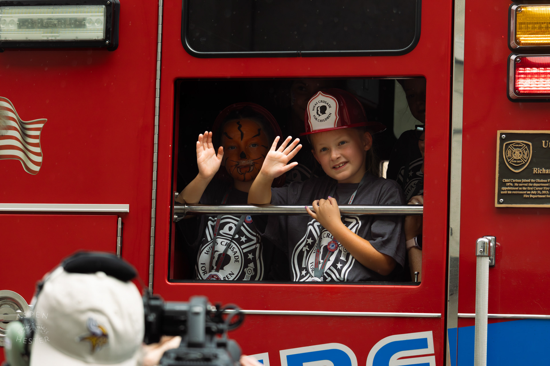Children Waving From an Okolona Firetruck Driving into The 71st Crusade for Children. June 2nd, 2024/Aspen Hester