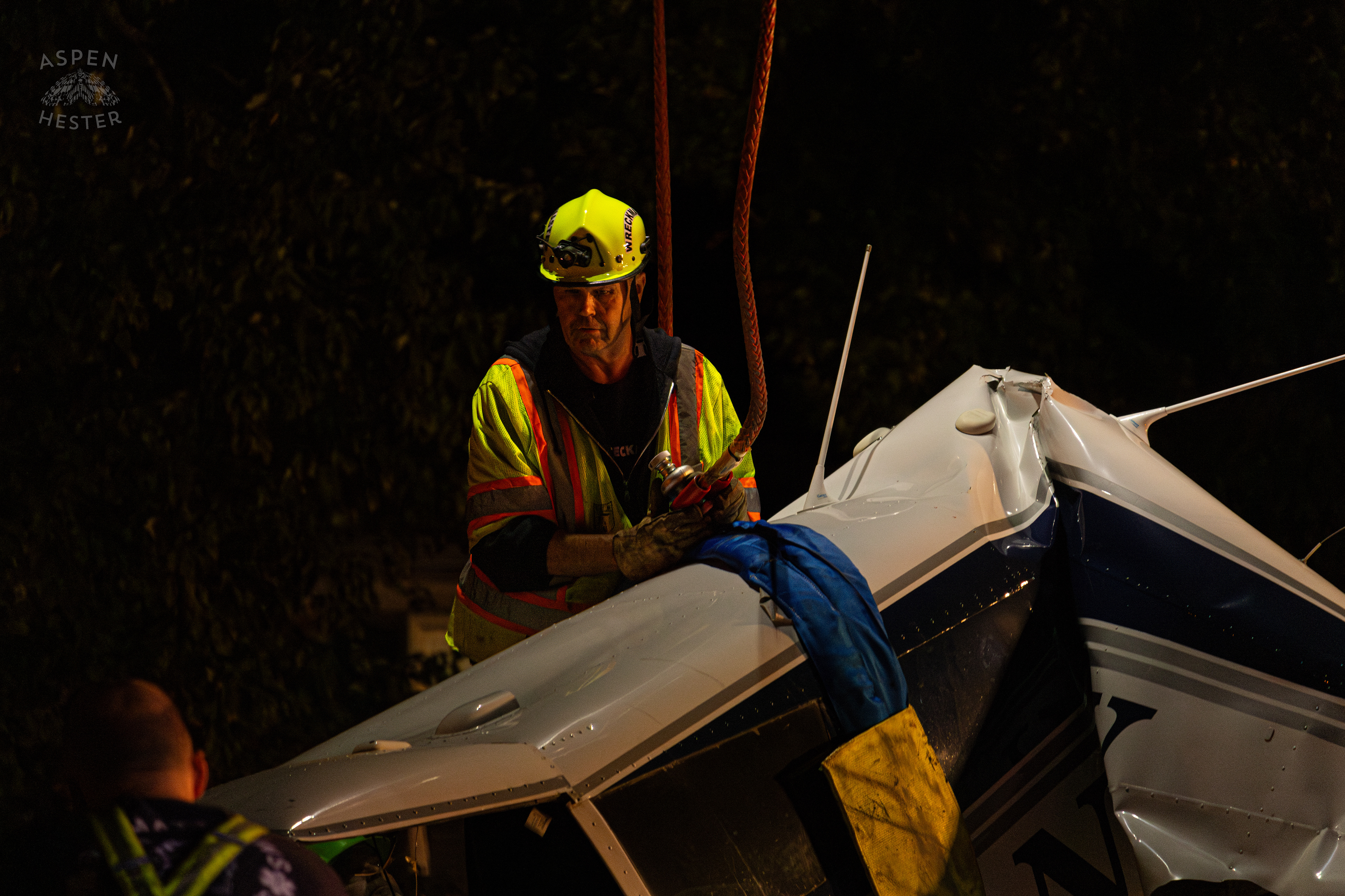 Tony’s Wreckers Crew Working to Remove The Piper Cherokee Plane from the Road after it Crash Landed, Taking Out Utility Poles, and Hitting A Car on Breckenridge Lane and Kresge Way. October 11th, 2024/Aspen Hester 