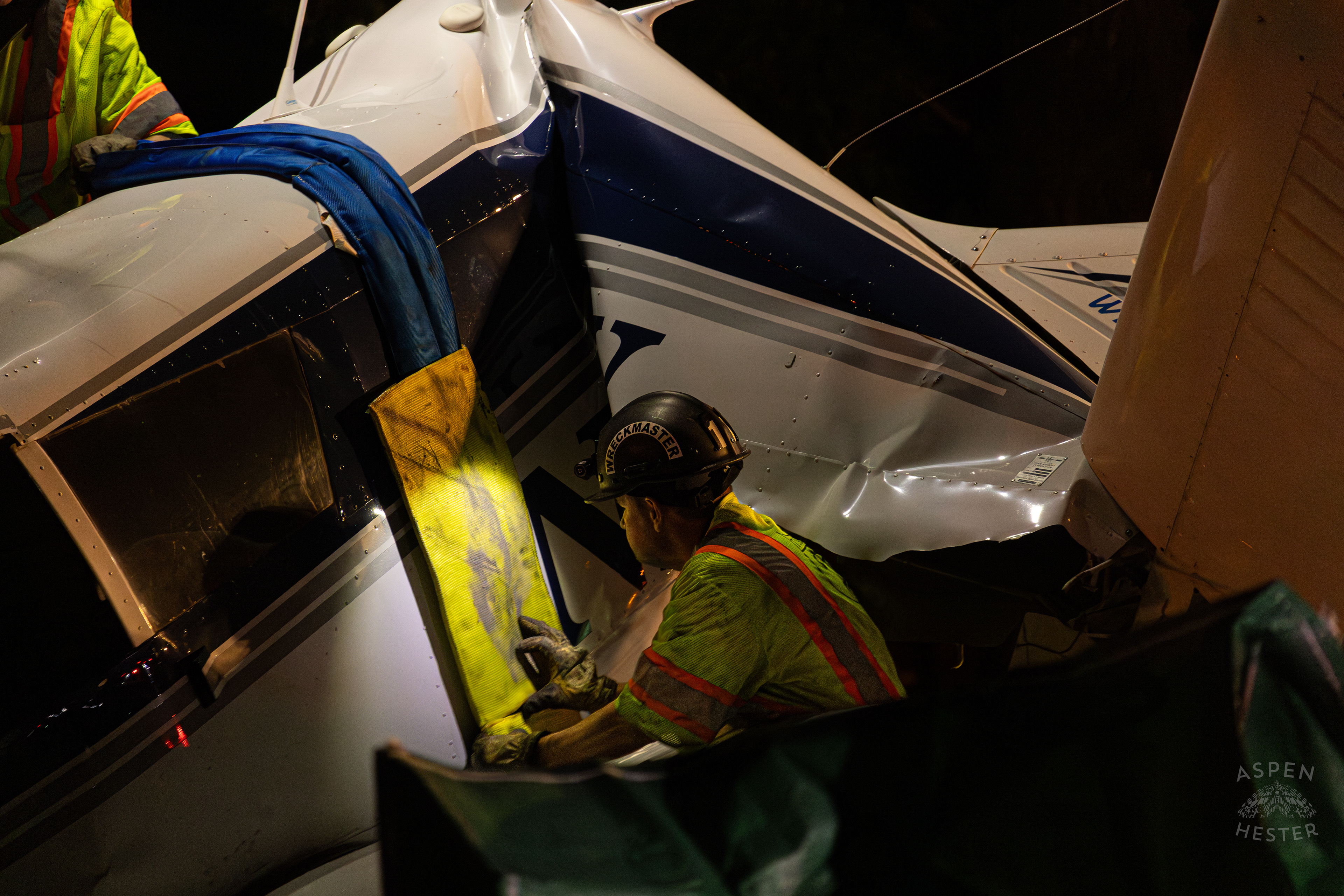 Tony’s Wreckers Crew Working to Remove The Piper Cherokee Plane from the Road after it Crash Landed, Taking Out Utility Poles, and Hitting A Car on Breckenridge Lane and Kresge Way. October 11th, 2024/Aspen Hester 