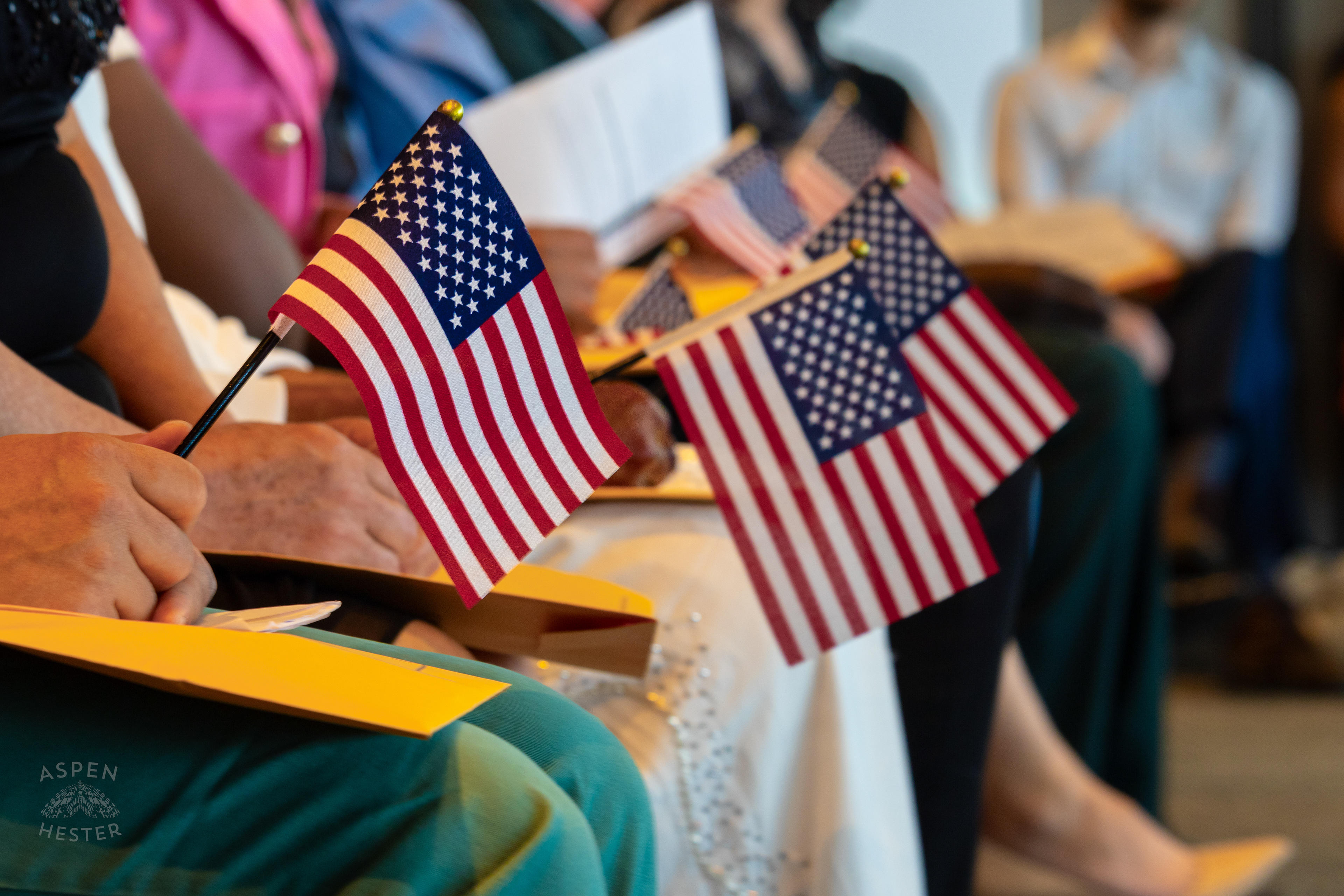 New Citizens Holding American Flags During WorldFest's Naturalization Ceremony. August 30th, 2024/Aspen Hester