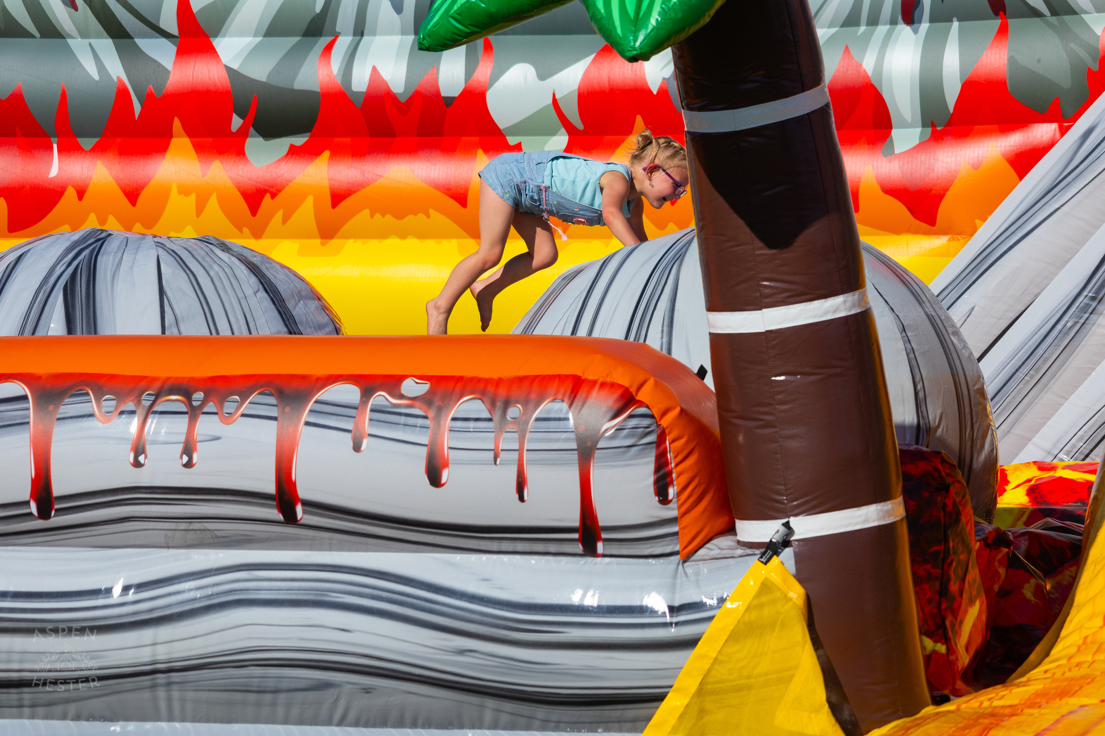 Kid Attempting to Make it Across "The Floor is Lava" at Play America with The Louisville Orchestra. July 5th, 2024/Aspen Hester