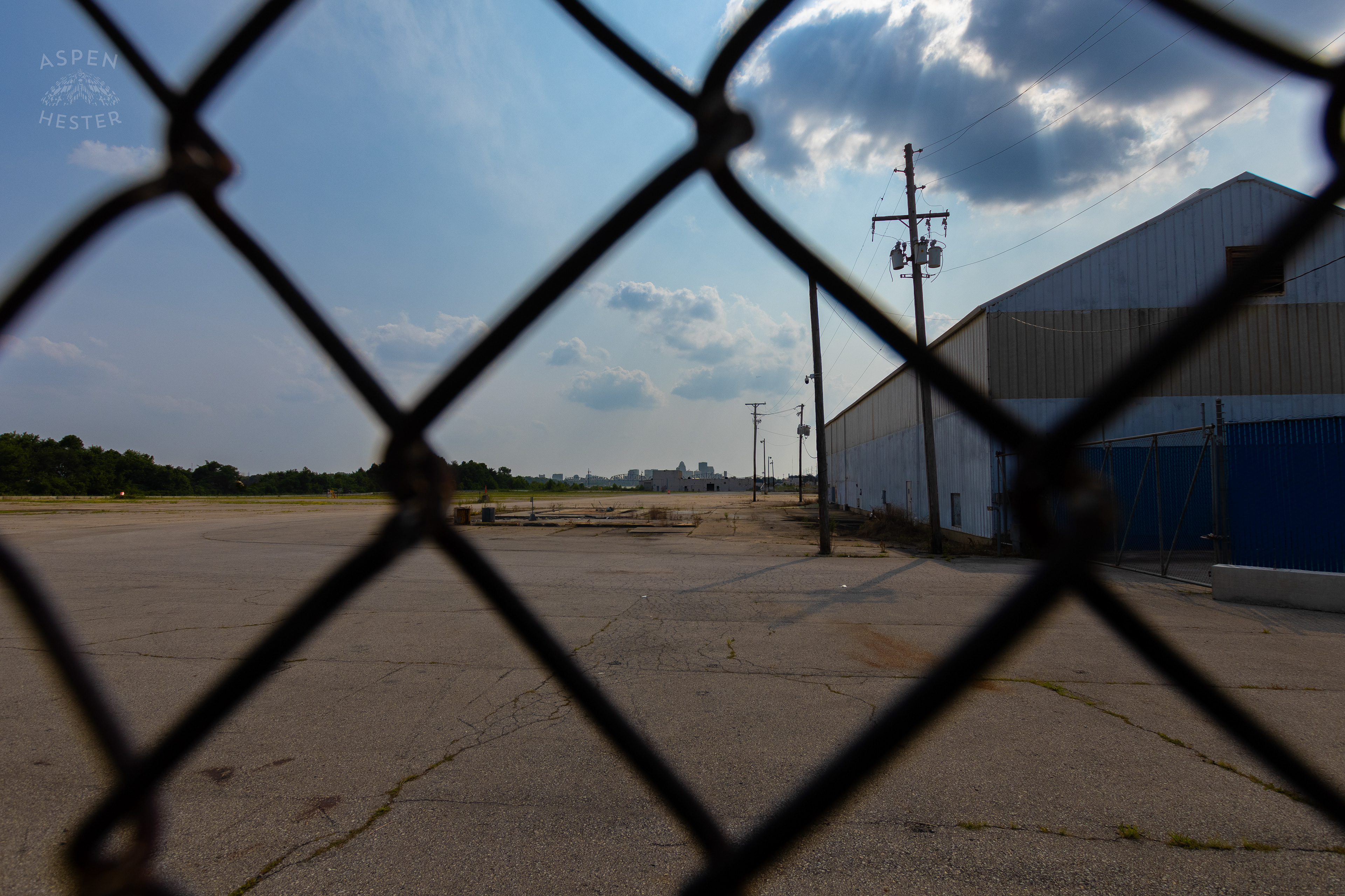 Looking Through the Chain Link Fence at the Abandoned Jeffboat Shipyard. July 26th, 2024/Aspen Hester