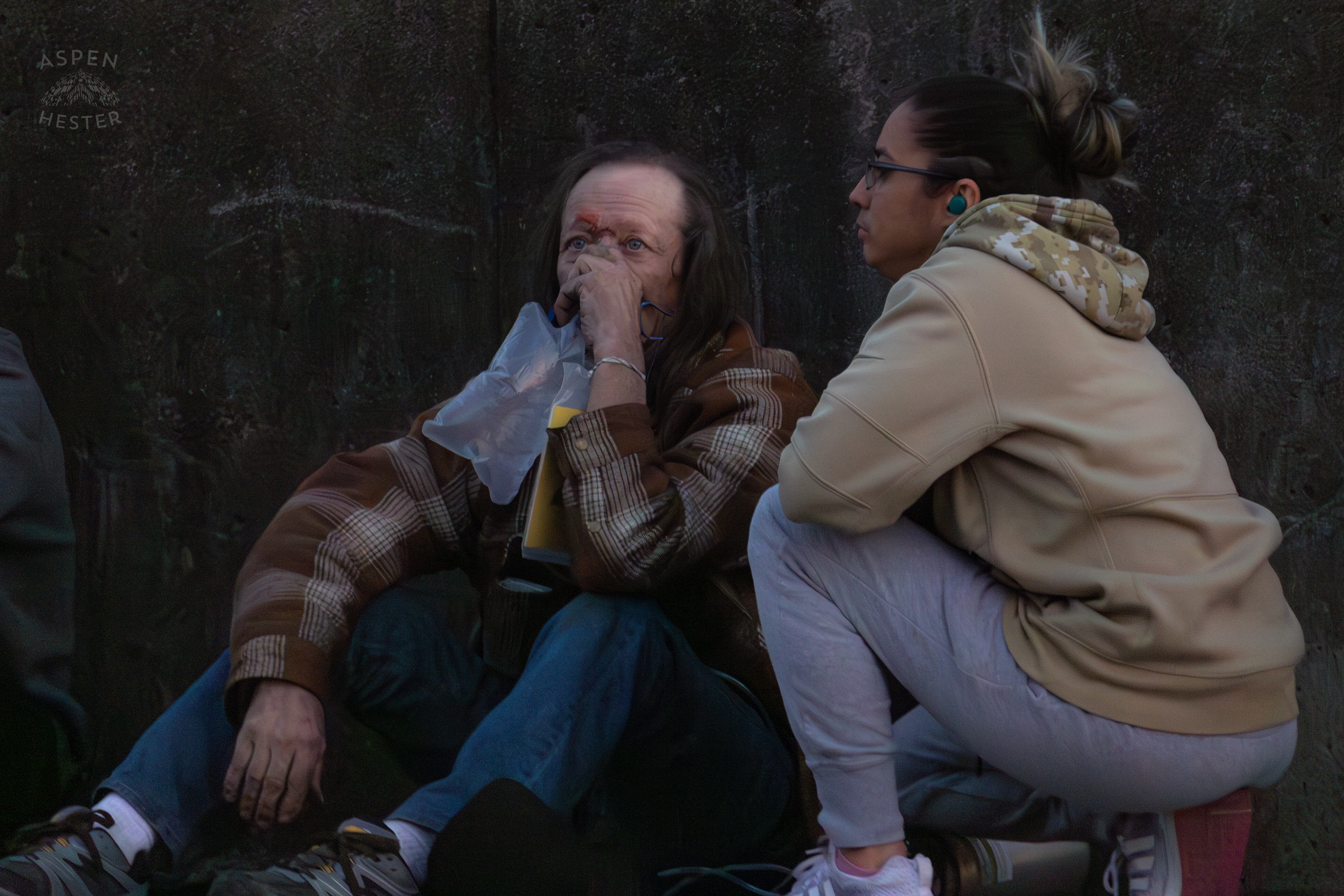 A Daughter Watches Over Her Father As He Takes Oxygen From Paramedics After Being Saved From The Parkview Tower Fire in New Albany Indiana. March 22nd, 2025/Aspen Hester